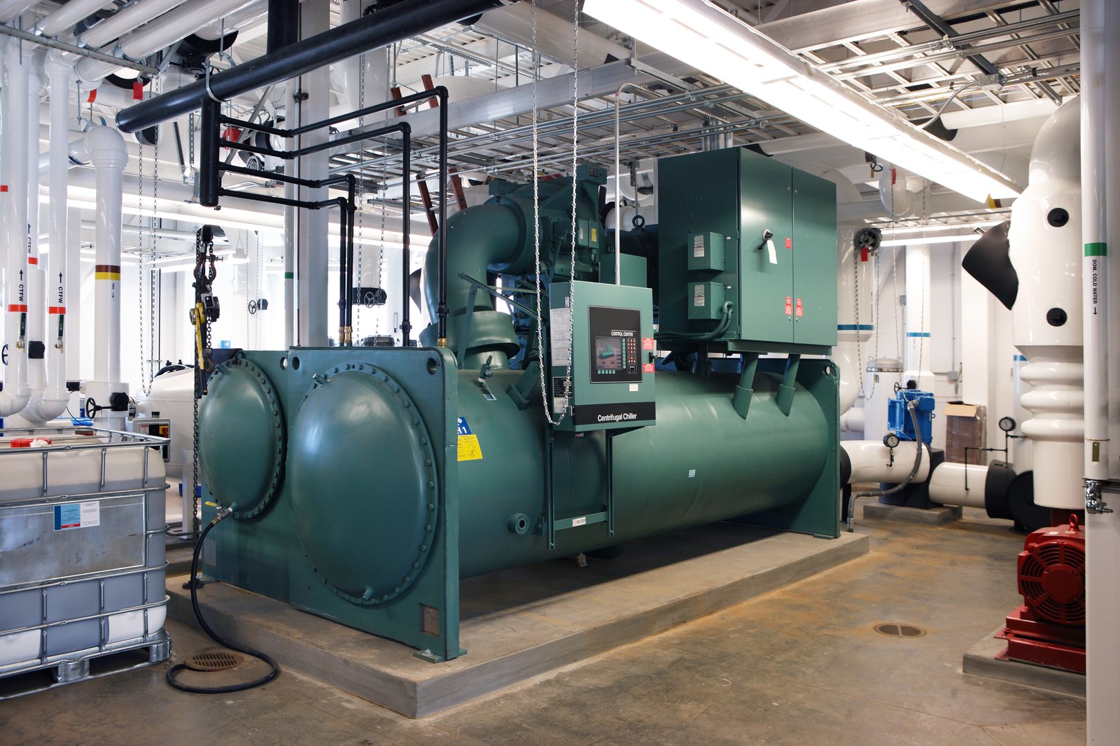 The water chiller in the mechanical room of a large building