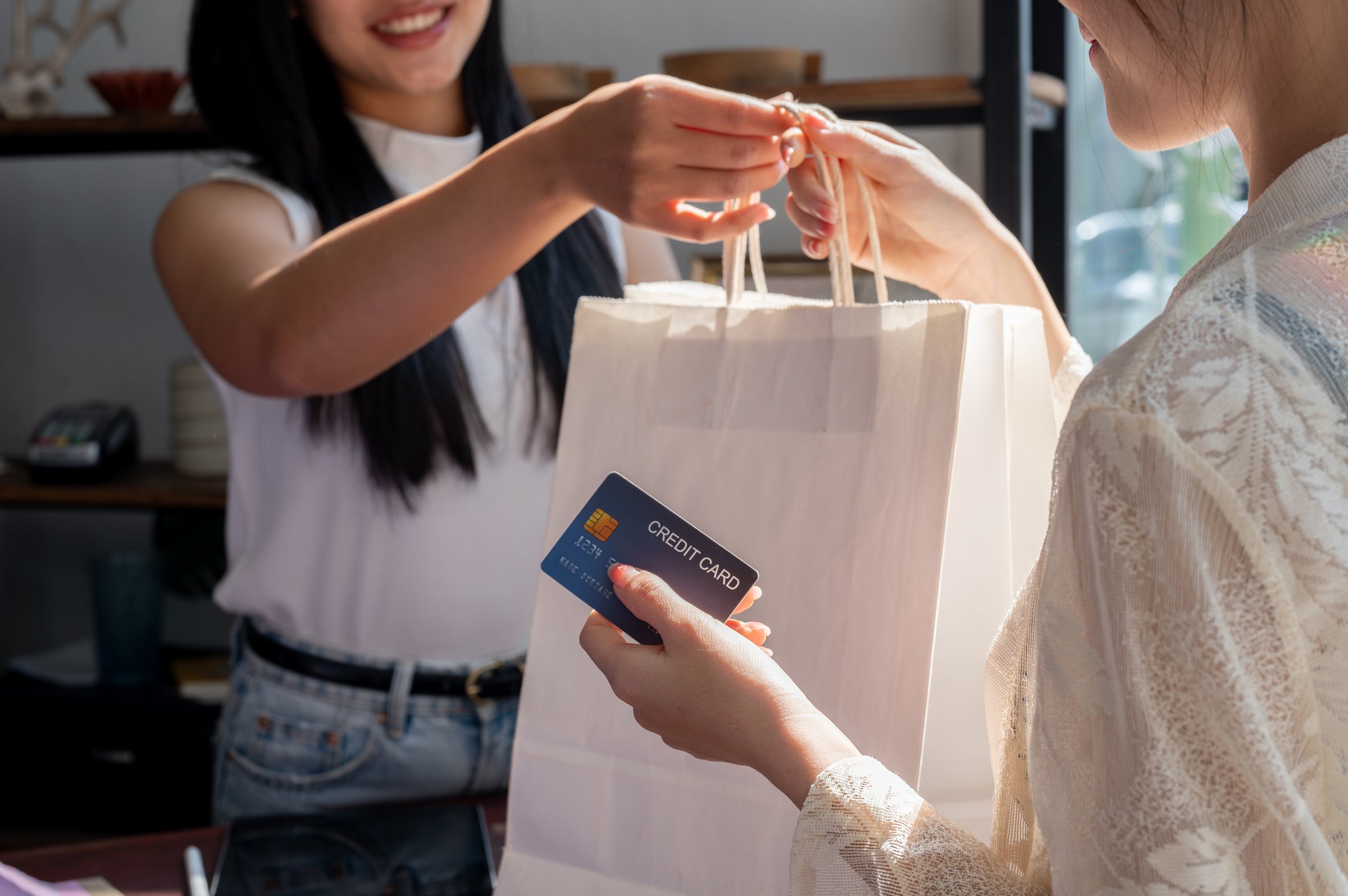 Friendly shop staff helping customer at counter with excellent service