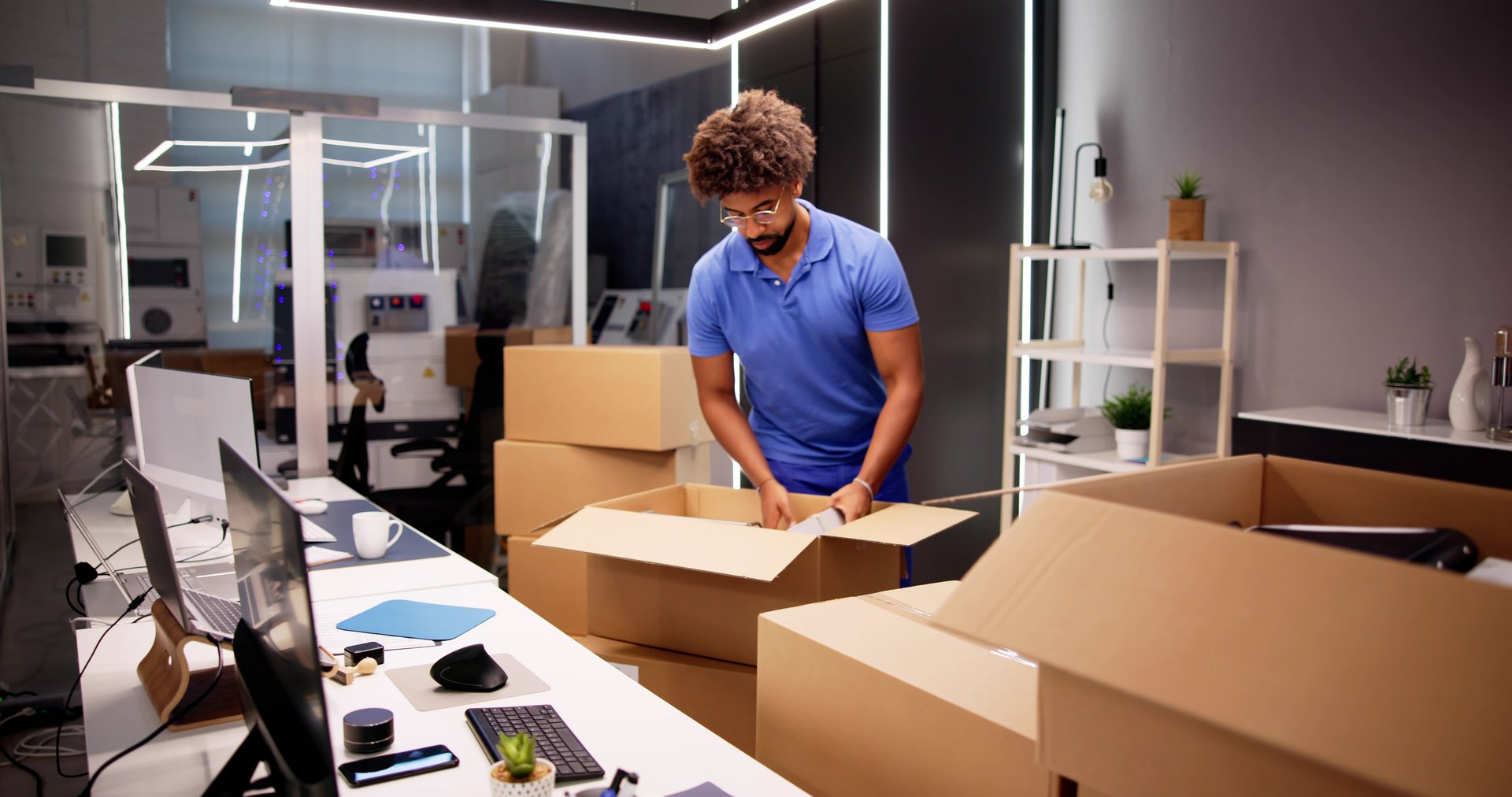 Professional Movers Packing Boxes In Modern Office