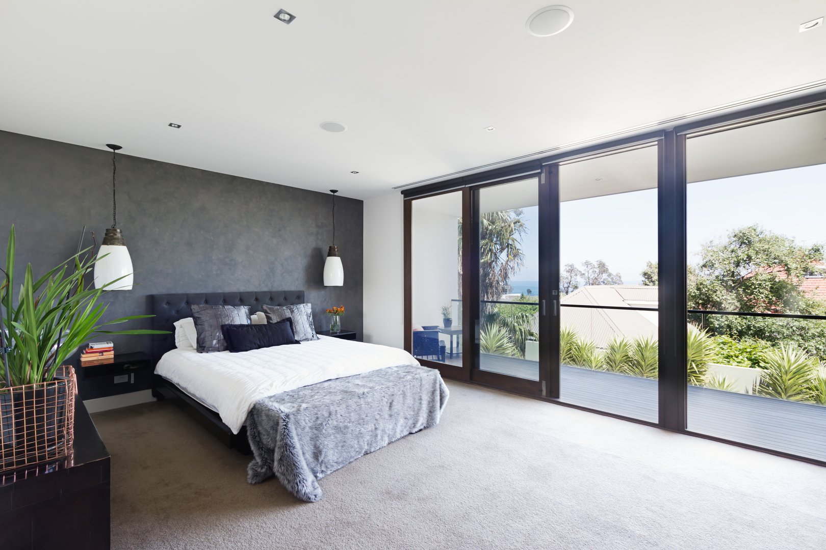 Spacious interior of designer master bedroom in luxury contemporary Australian home