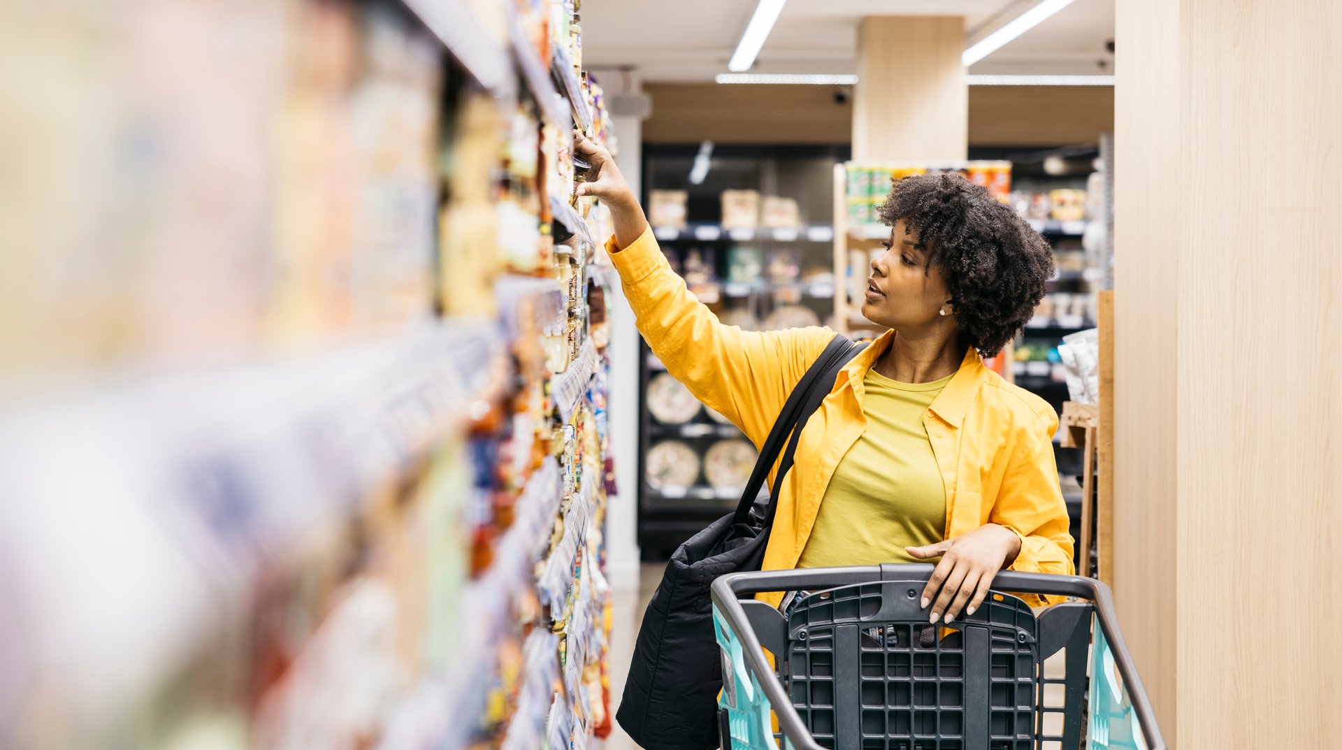 Customer choosing products in supermarket while grocery shopping