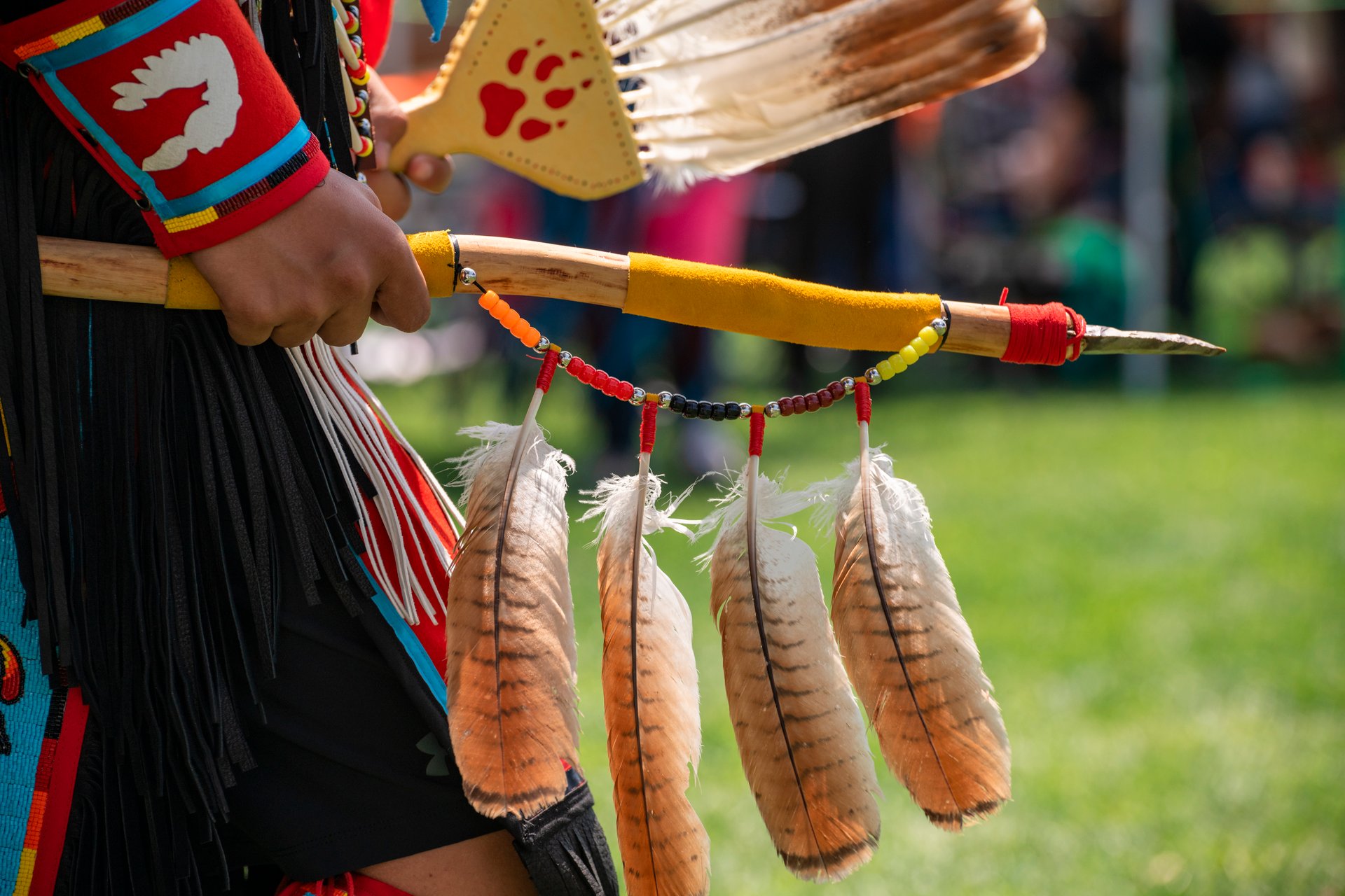 The dance stick is usually a  wooden rod decorated with fabric, feathers, and beads. It is held in the hand while dancing.