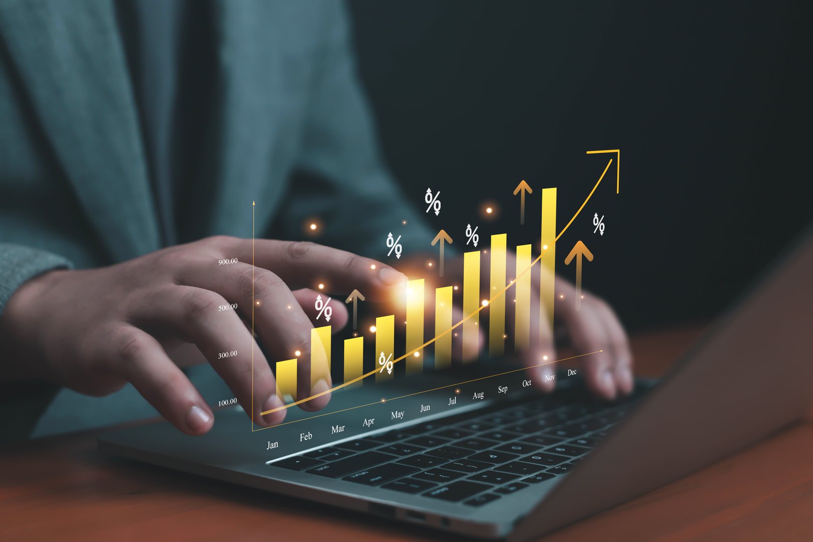 Hands typing on laptop with glowing financial growth chart, symbolizing business success, investment, interest percent data analytics, profit increase, market trends, and economic development concepts.