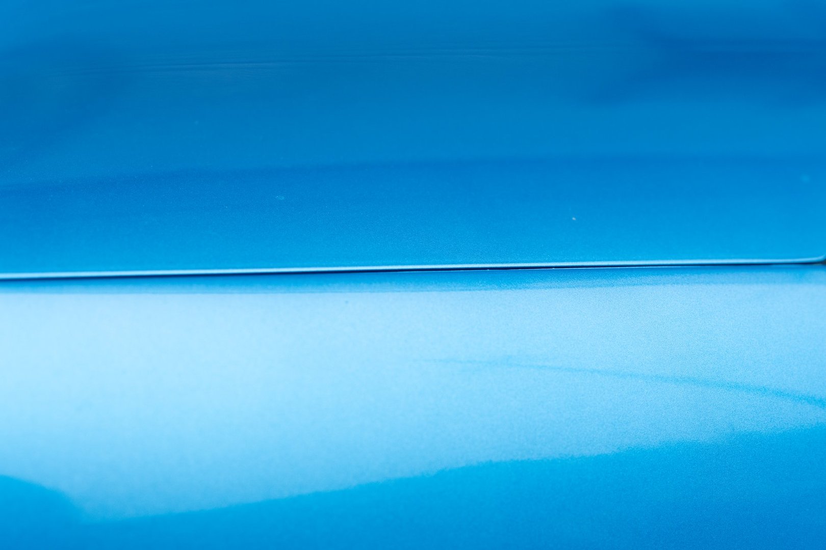 The surface of the blue car's paint