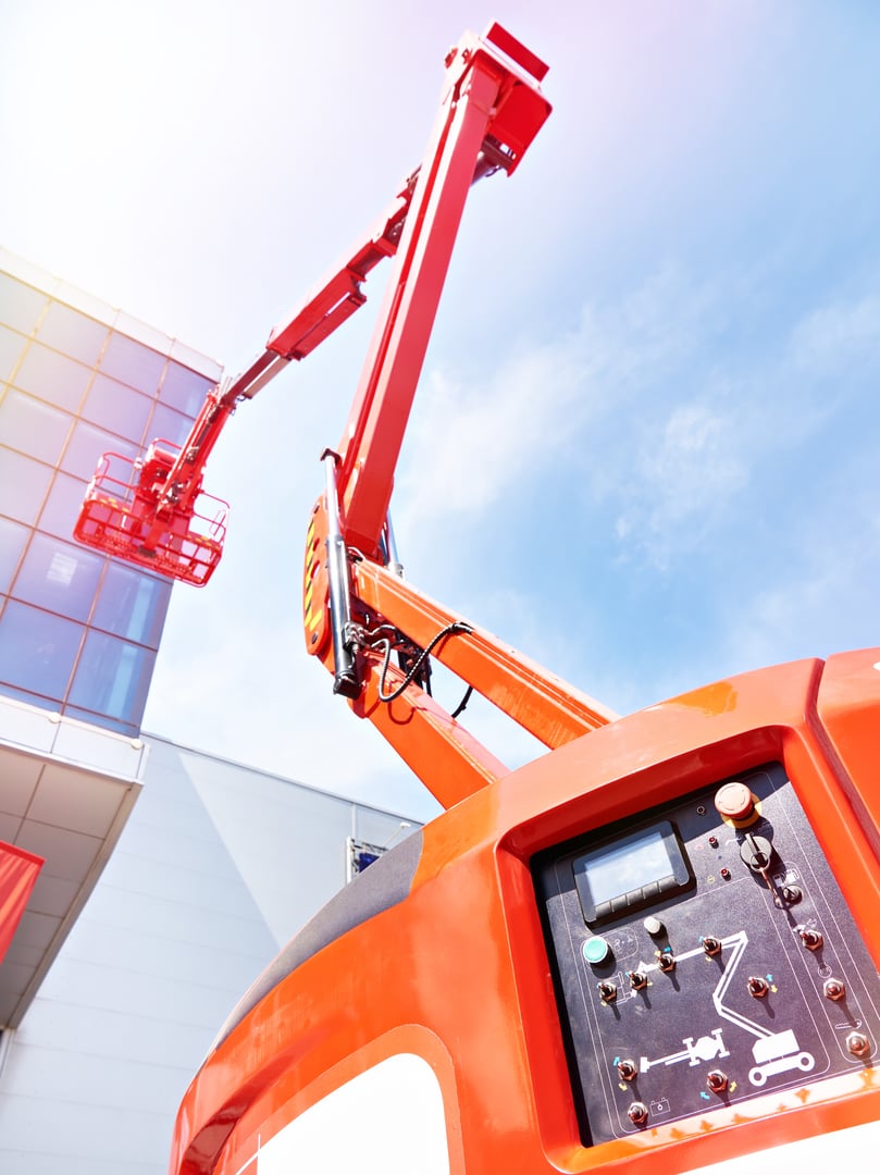 Truck mounted cranes with cradle on blue sky