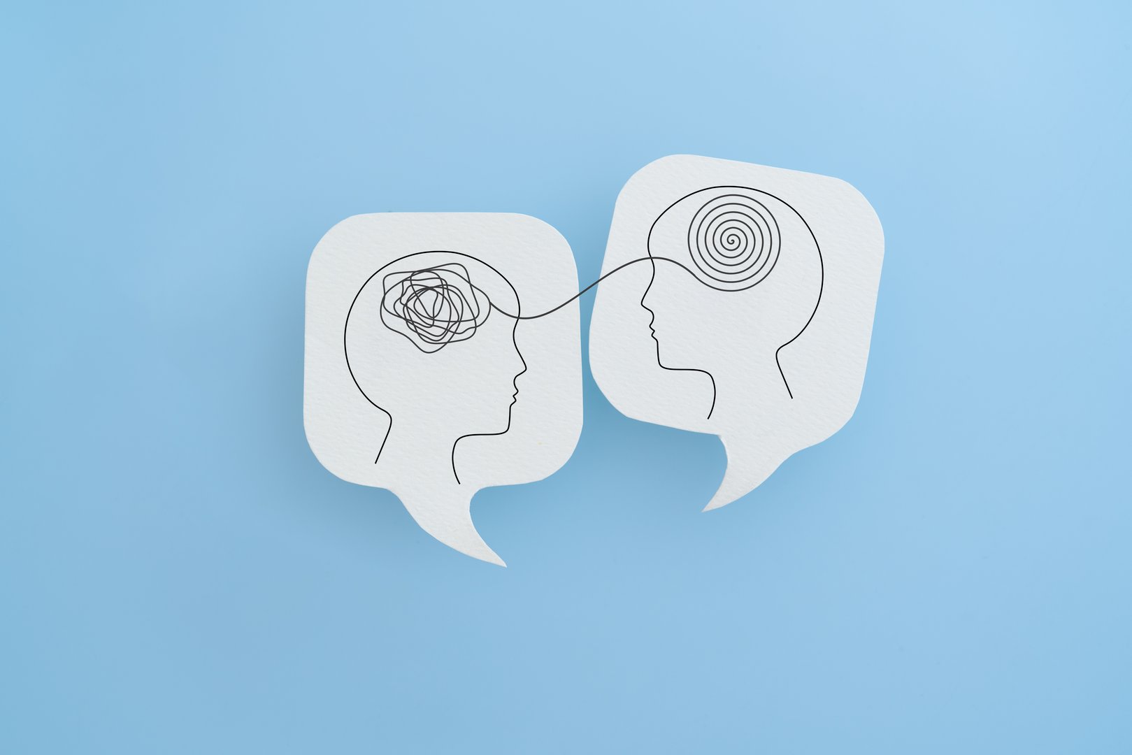 Mental health, brain disorder, World mental health day, Alzheimer, Psychology concept. Human head with Tangle of thoughts and clear line on real white speech bubble paper cut with blue background