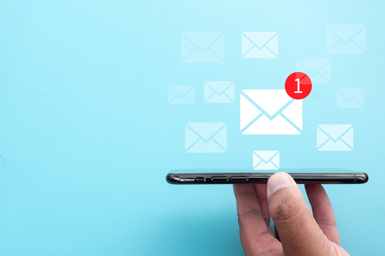 Email notification icon on smartphone holding by hand representing new messages alert, online communication,inbox updates,igital communication.