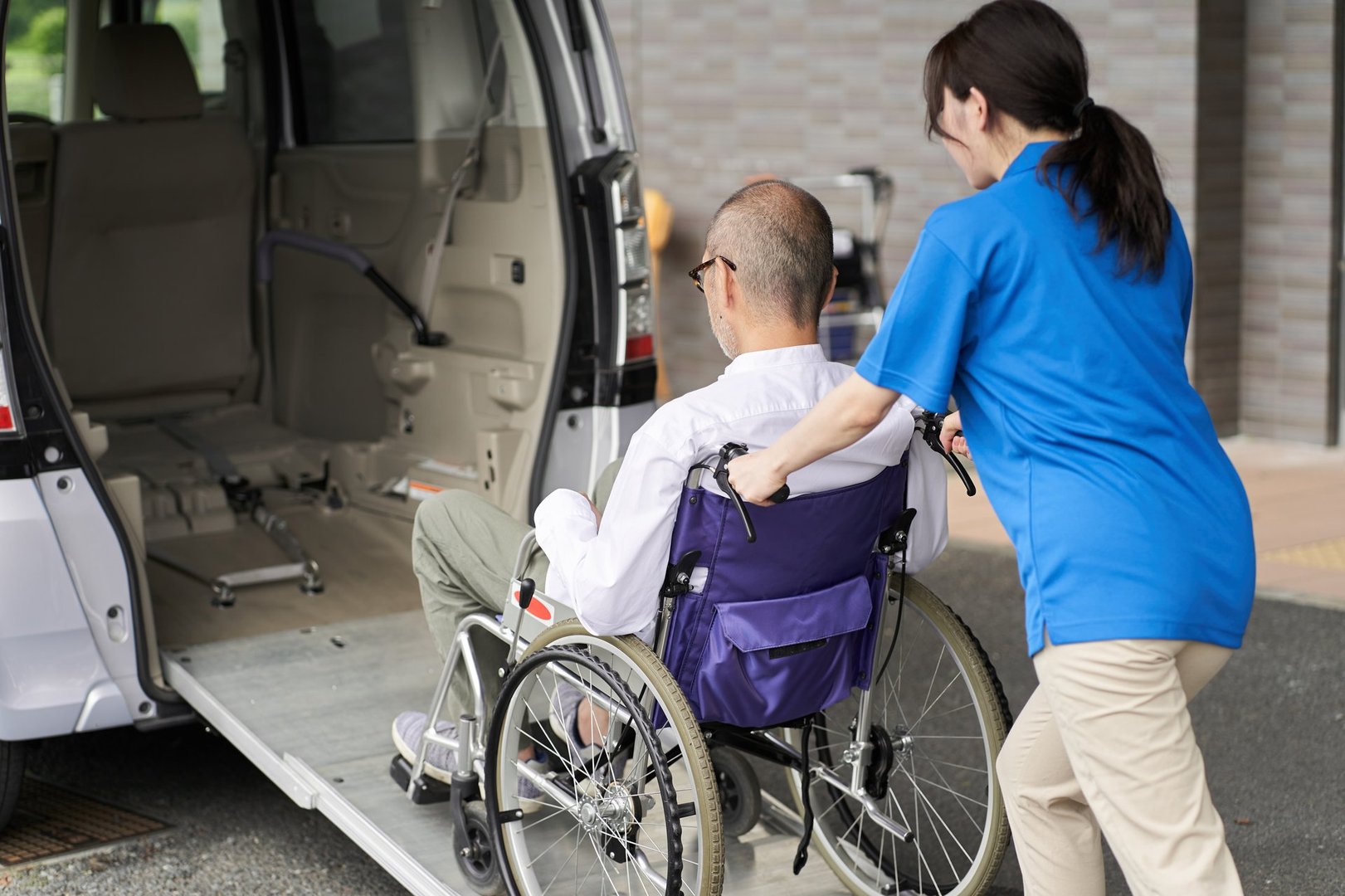 Professional caregiver assisting with wheelchair