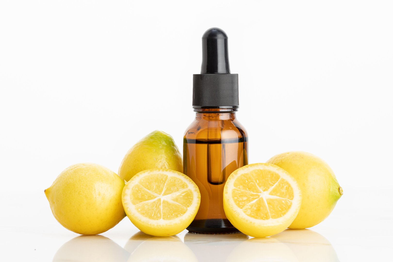 Lemon essential oil on white background. Citrus oil