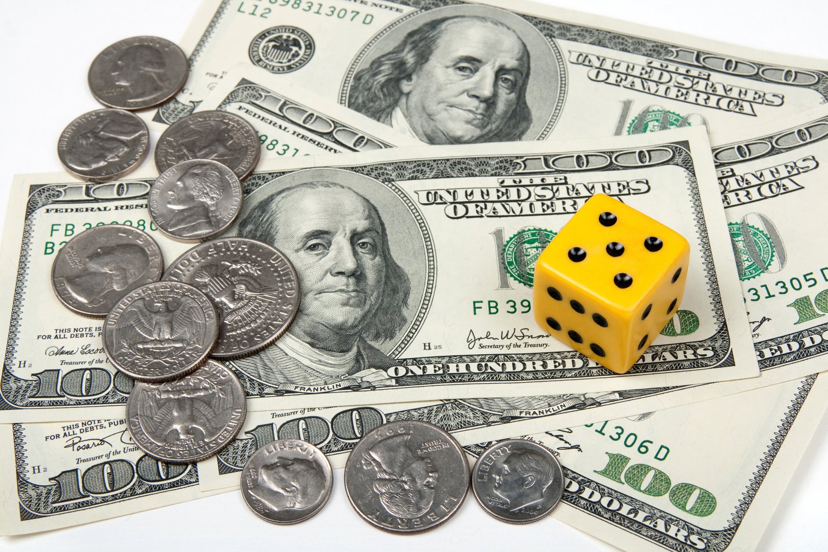 Yellow dice, paper money and coins. Gambling concept.