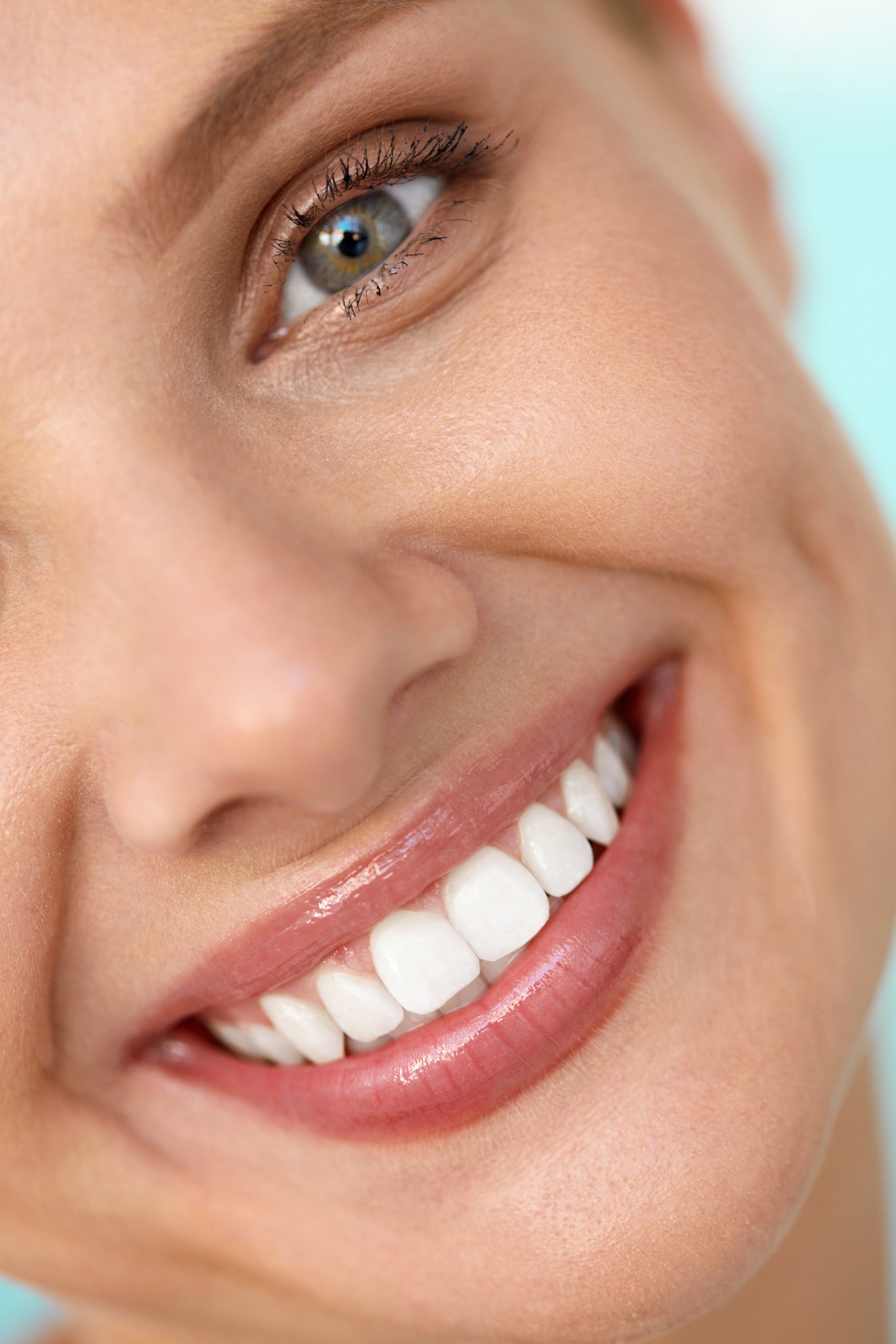 Beautiful Smile. Closeup Of Beautiful Happy Smiling Woman With White Teeth And Fresh Face. Beauty Girl With Cosmetic Lip Balm On Her Full Lips. Dental Health, Lip Care Concept. High Resolution Image