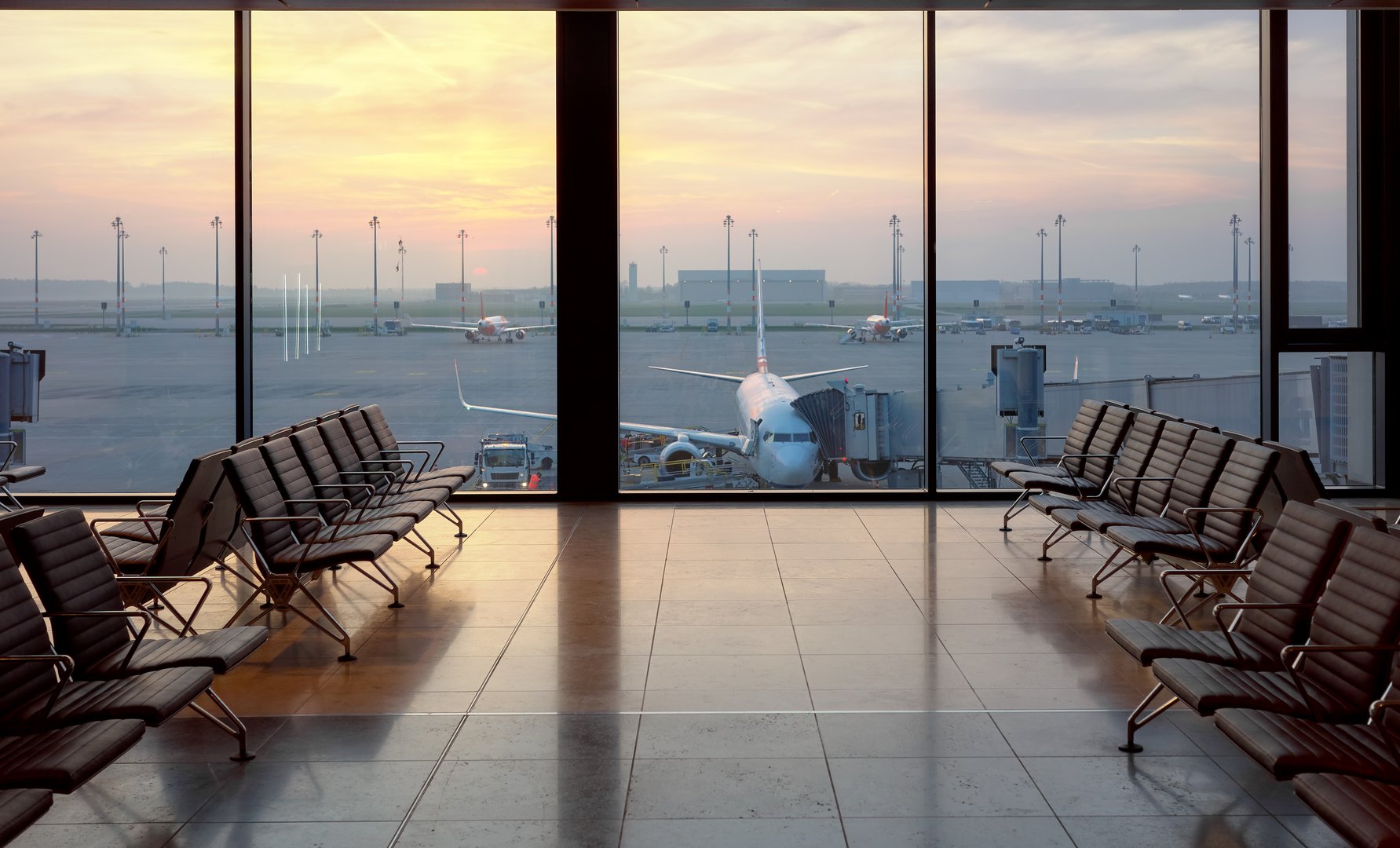 Airport departure lounge at sunset, travel concept.