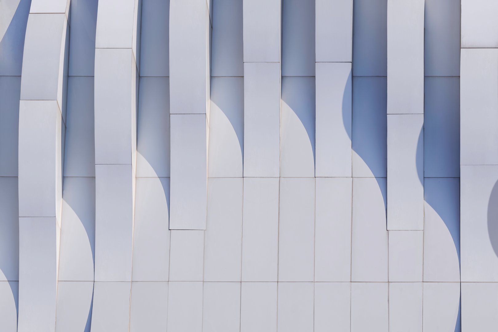 Dimension curve lines of gray aluminum composite tile wall decoration of modern building with light and shadow on surface, Geometric exterior architecture background in Minimal style