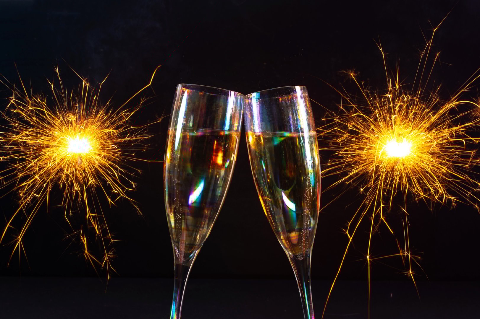 Happy New Year 2026, New Year's Eve holiday greeting card celebration. Sparklers firework, champagne glasses on black background 20