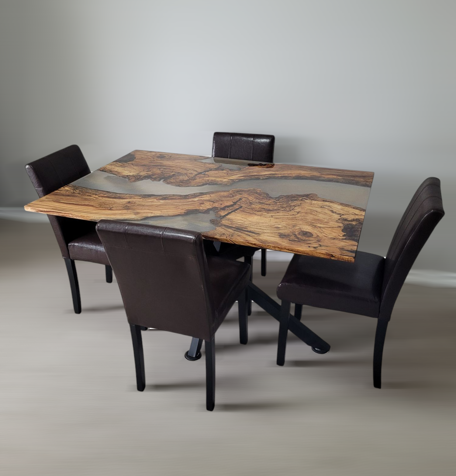 Wooden dining table with a natural pattern and four dark cushioned chairs in a modern setting.