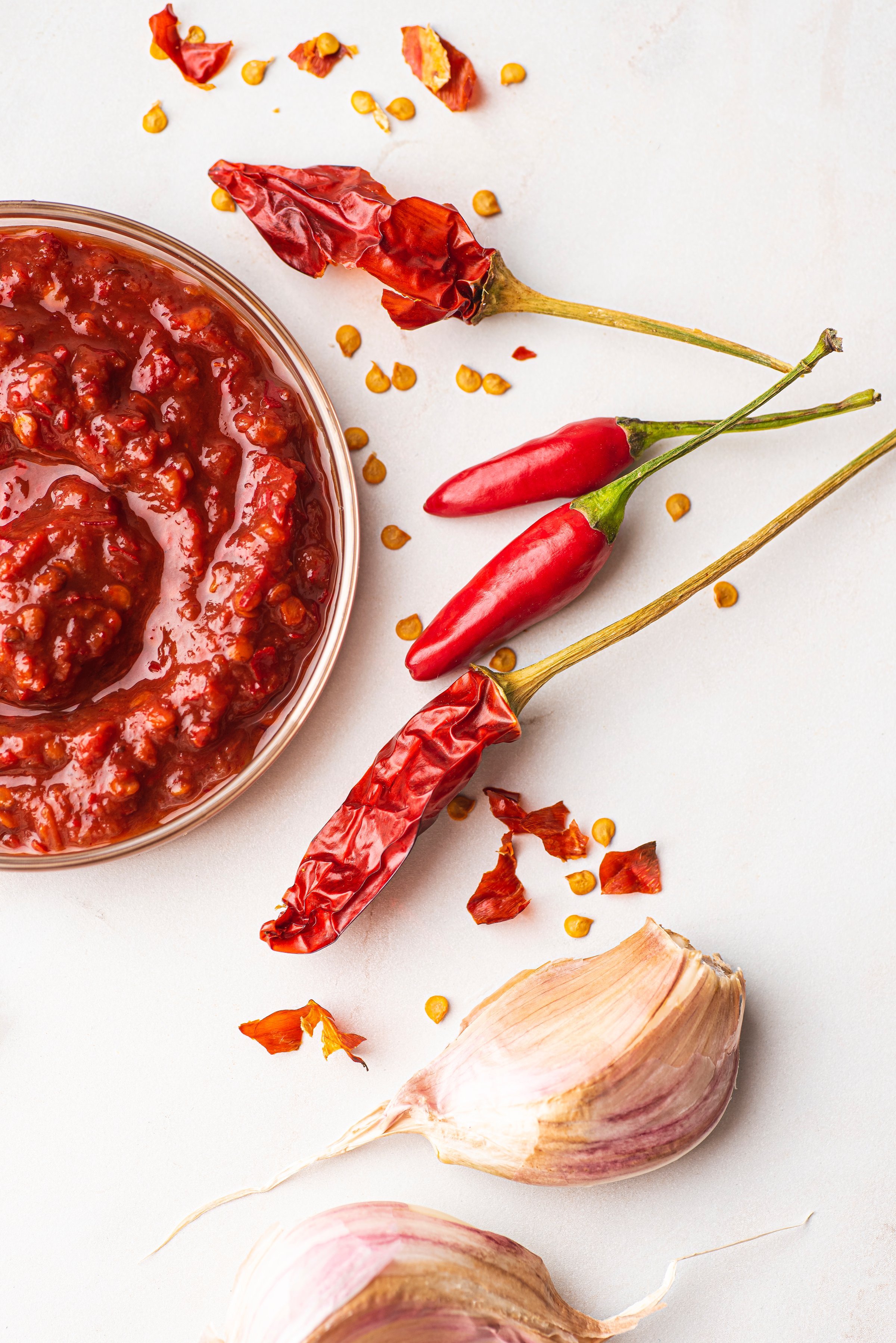 Spicy Harissa sauce or pasta recipe. North African and Middle Eastern spicy Harissa sauce, made at home using a few simple ingredients: vibrant red in color and adds smokiness, vegan, gluten free