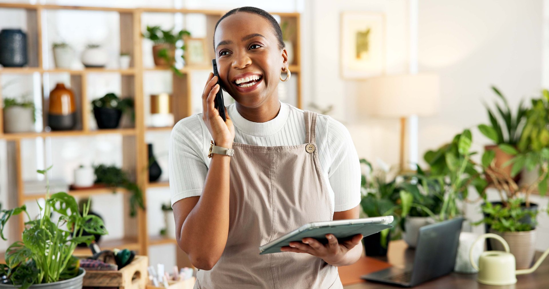 Phone call, tablet and thinking with black woman florist in office for online order confirmation. App, communication and conversation with happy African person in plant nursery for retail sales
