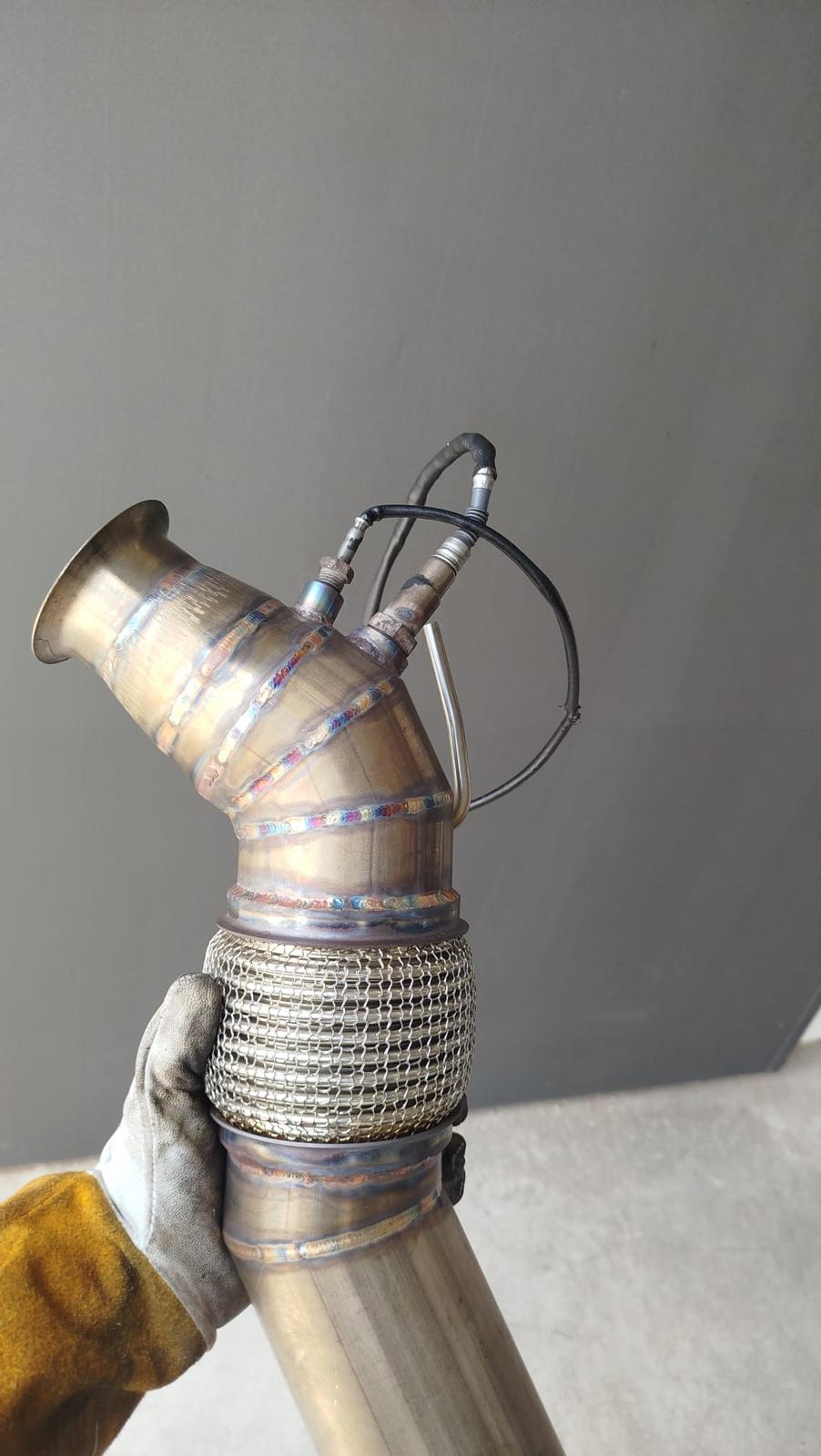 Shiny exhaust pipes. Motor parts, automotive V12 engine fragment, closeup photo with selective focus