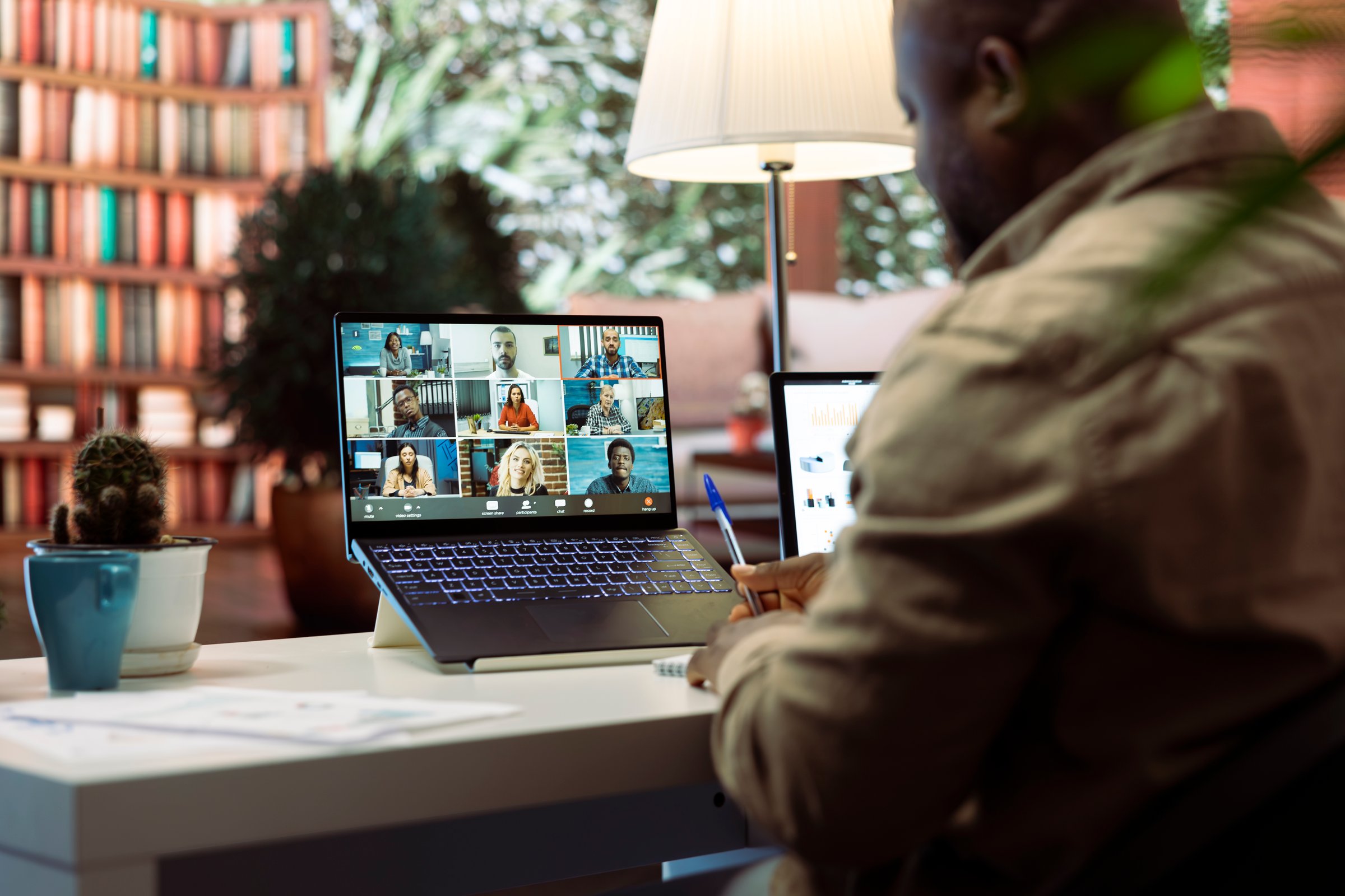 Businessman conducting a videocall meeting online with shareholders, reviewing data analytics and statistics to obtain funds for investment and development strategy. Startup growth.