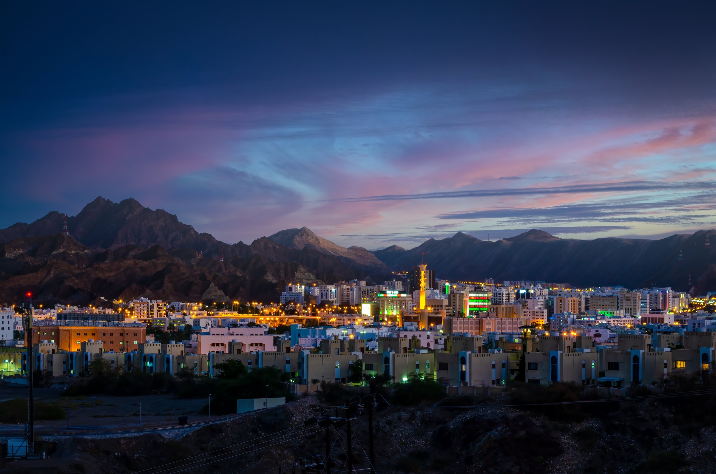 Illuminated buildings during an evening in Muscat, Oman with beautiful sky in the background