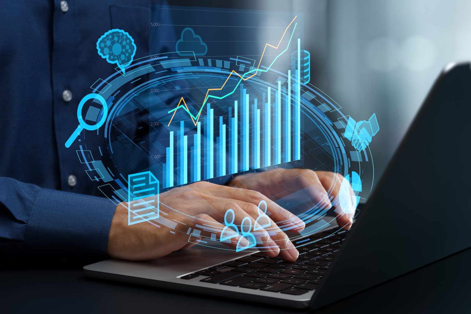 Businessman using laptop computer to view analytics graph.