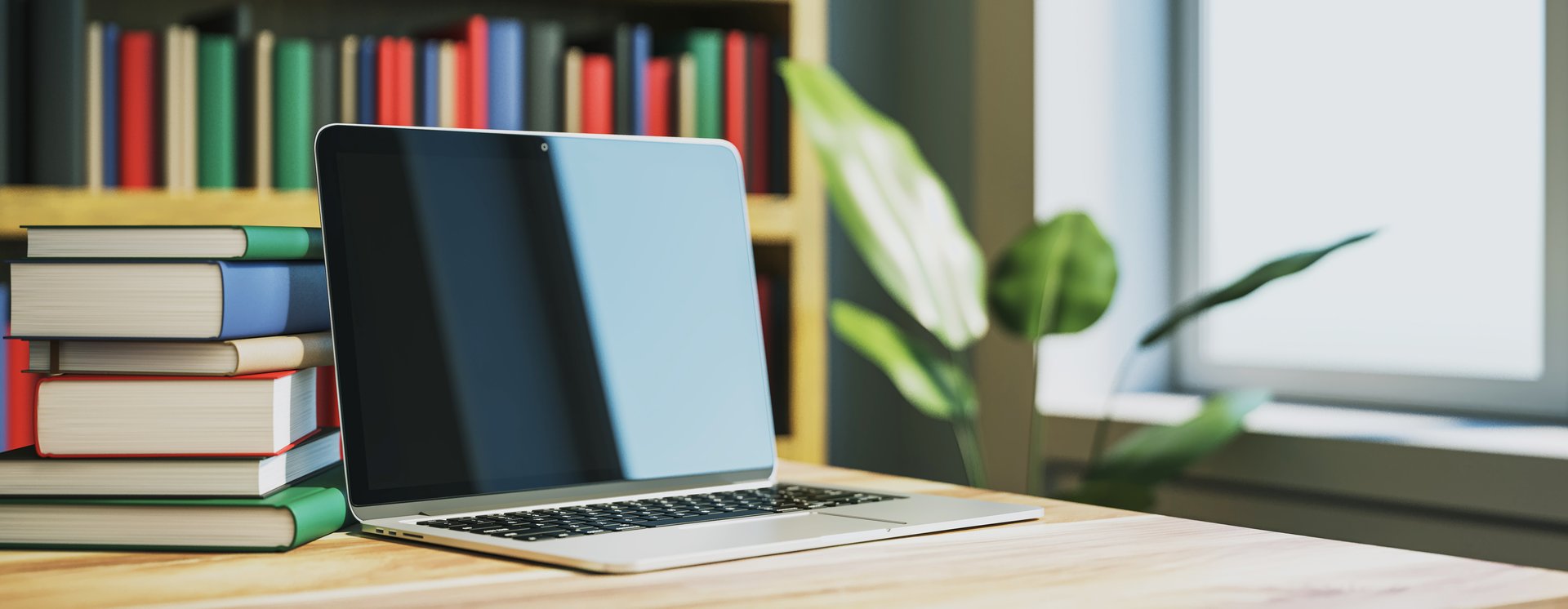 A laptop on a wooden desk beside a stack of books in a modern library room with a window and plant in the background. Concept of online education. 3D Rendering