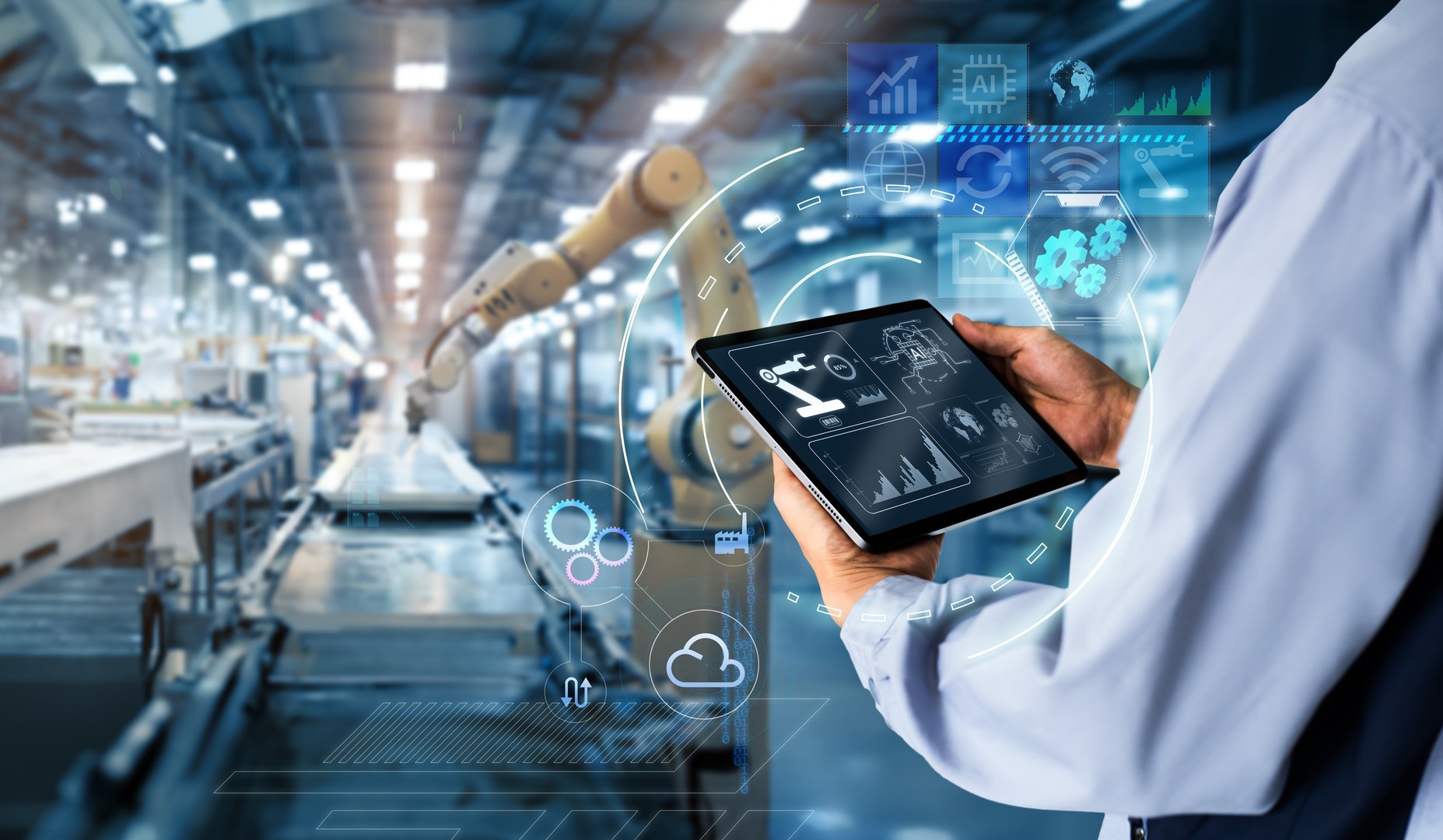 Hands holding tablet on blurred automation machine as background