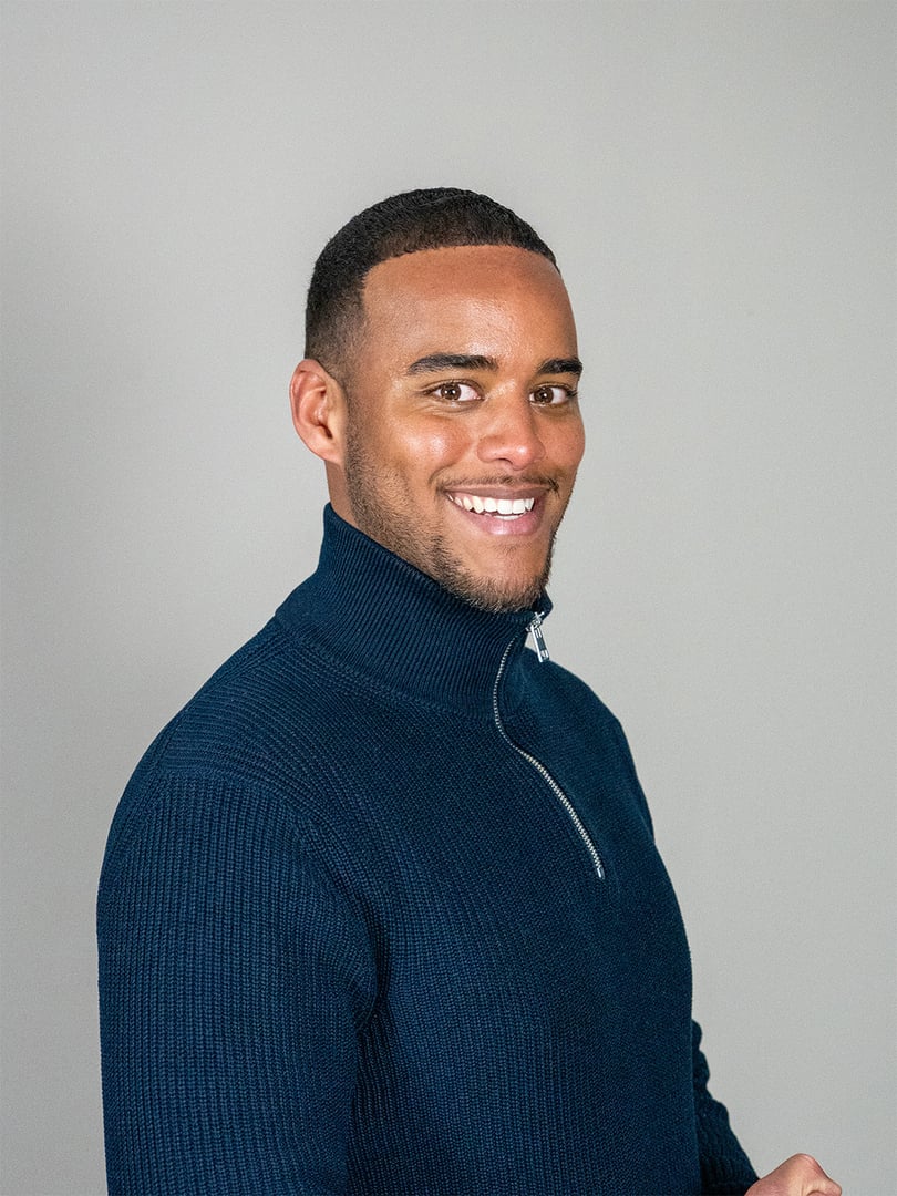 Diverse group of confident business professionals walking toward camera in a bright modern office, smiling and united in teamwork, leadership and a positive, determined future