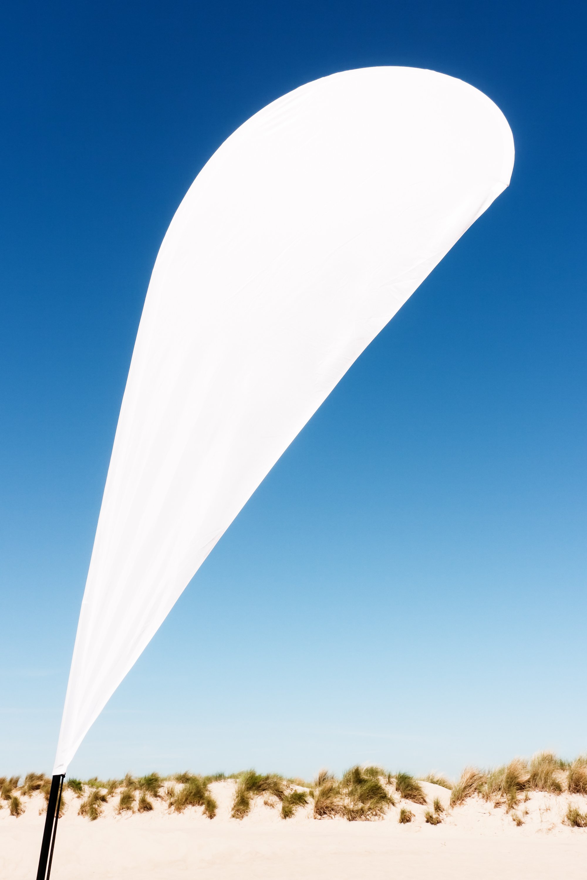 modern beach flag at a beach (northsea) - nice background with space for text