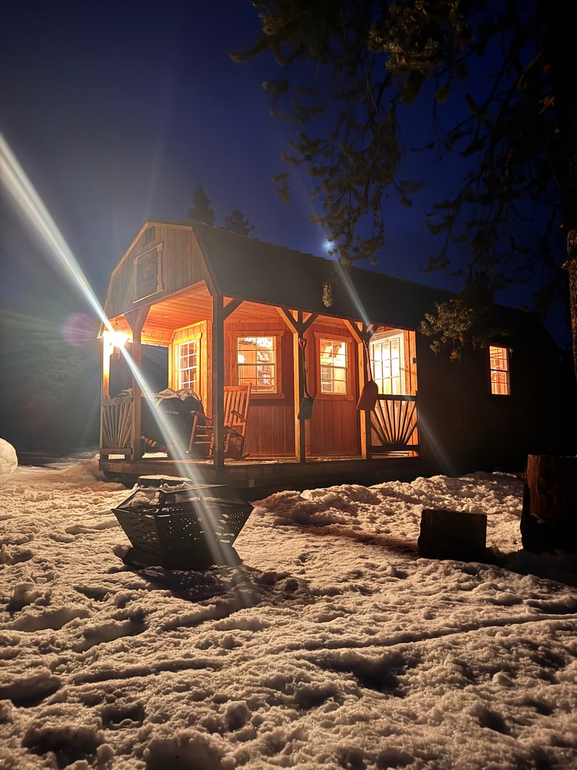 Warming cabin illuminated at night