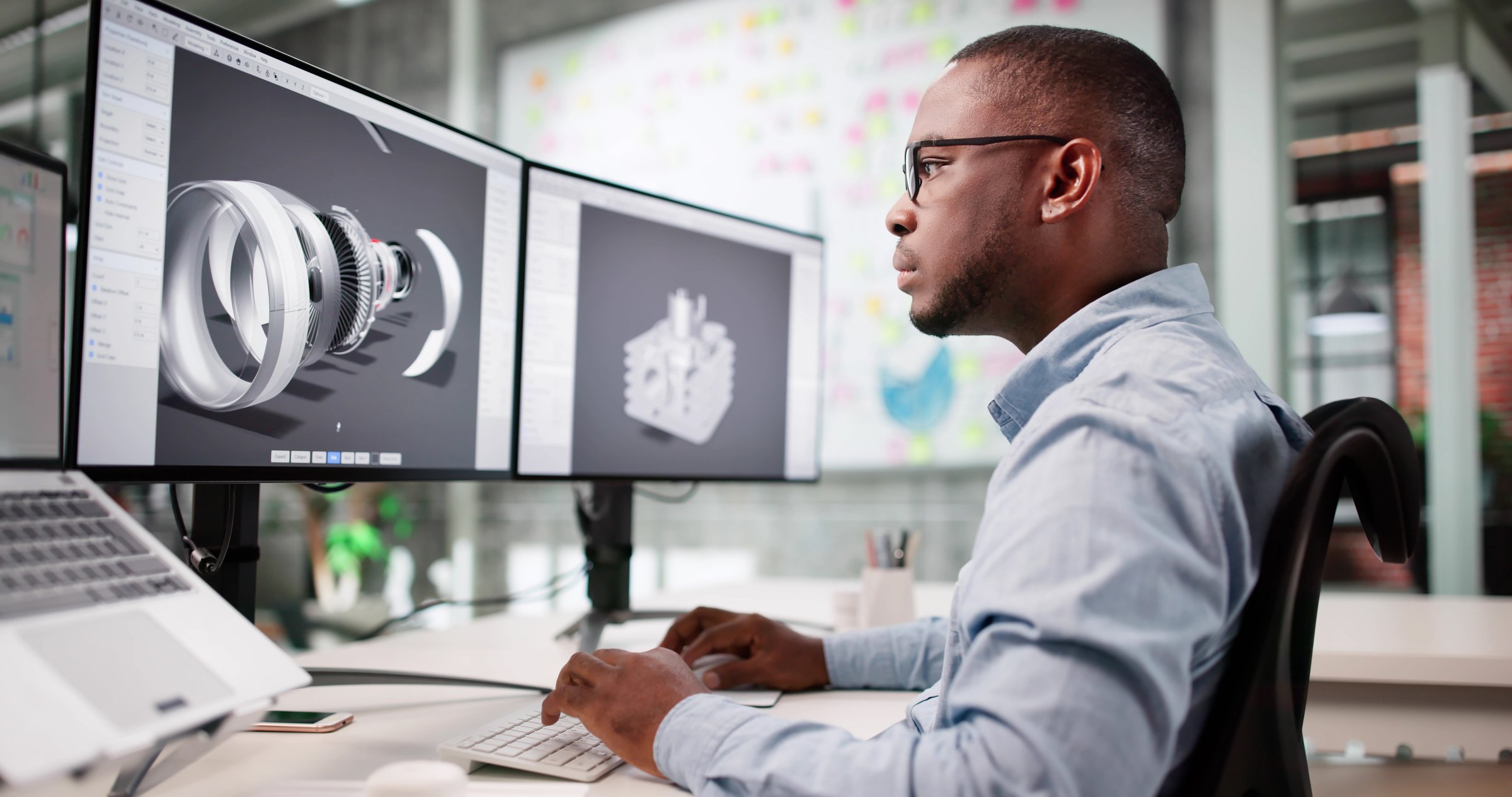 African-American Man Develops Jet Aircraft Engine Design On Laptop Software.