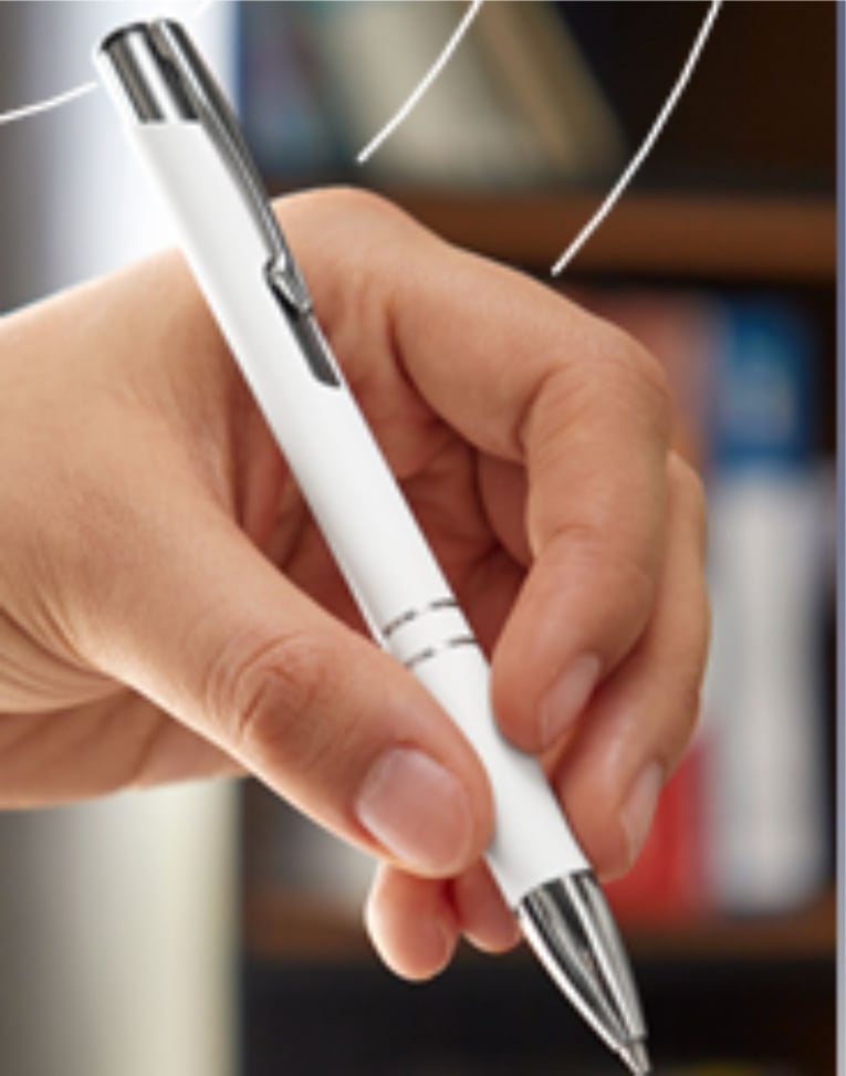 A hand holding a white and silver pen with a blurred background.