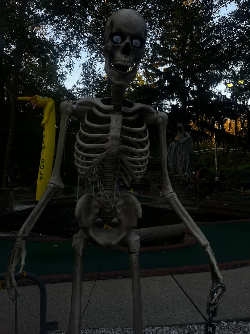 Eerie Halloween mini golf setup with haunting decorations and special effects