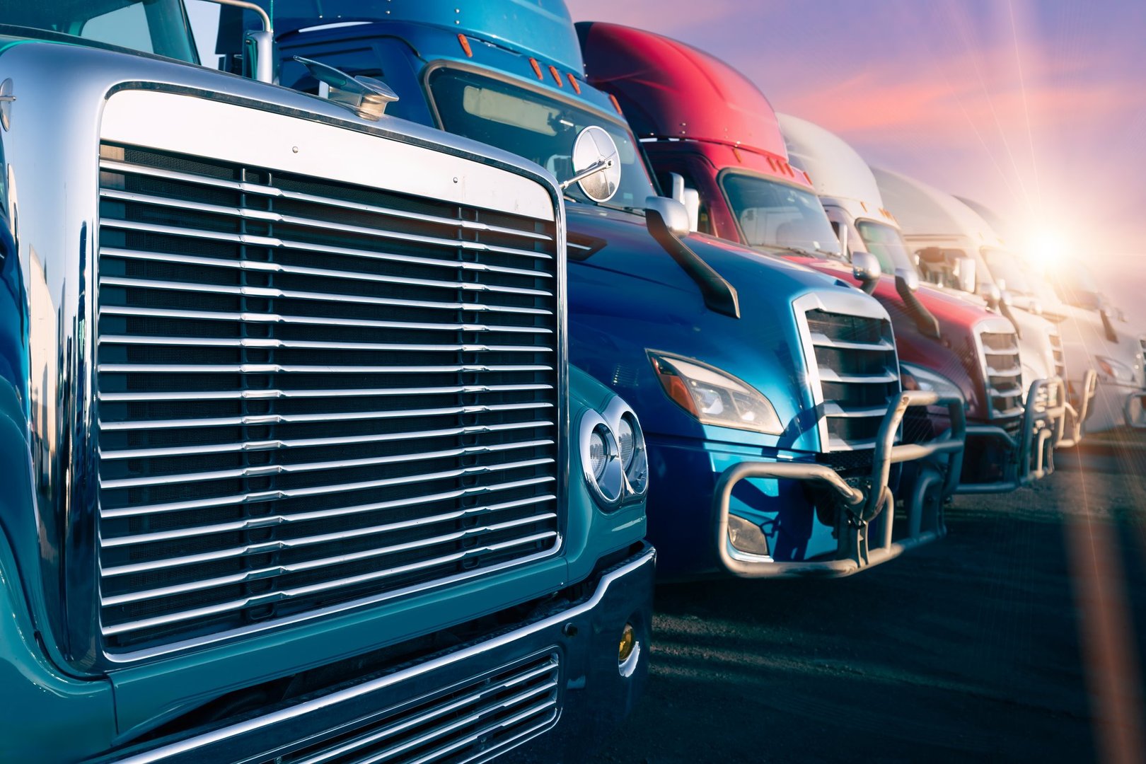Long haul container trucks carrying commercial cargo on a parking lot ready for delivery.