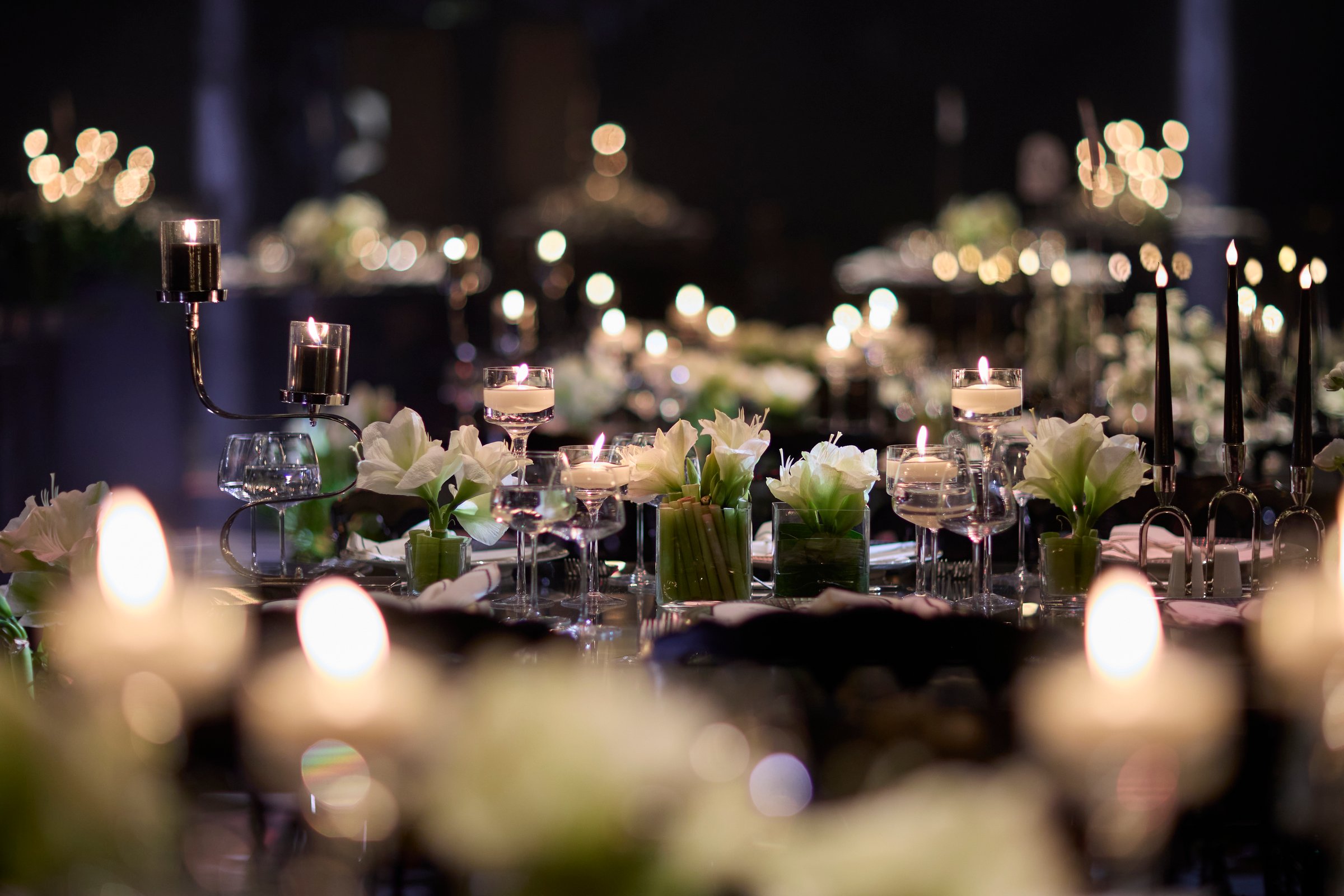 Elegant banquet tables illuminated by candlelight