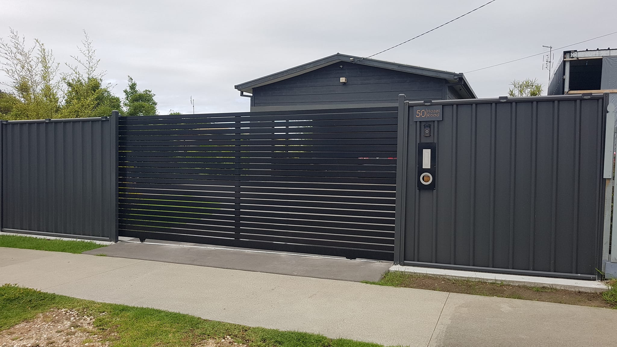 Workers installing metal fence