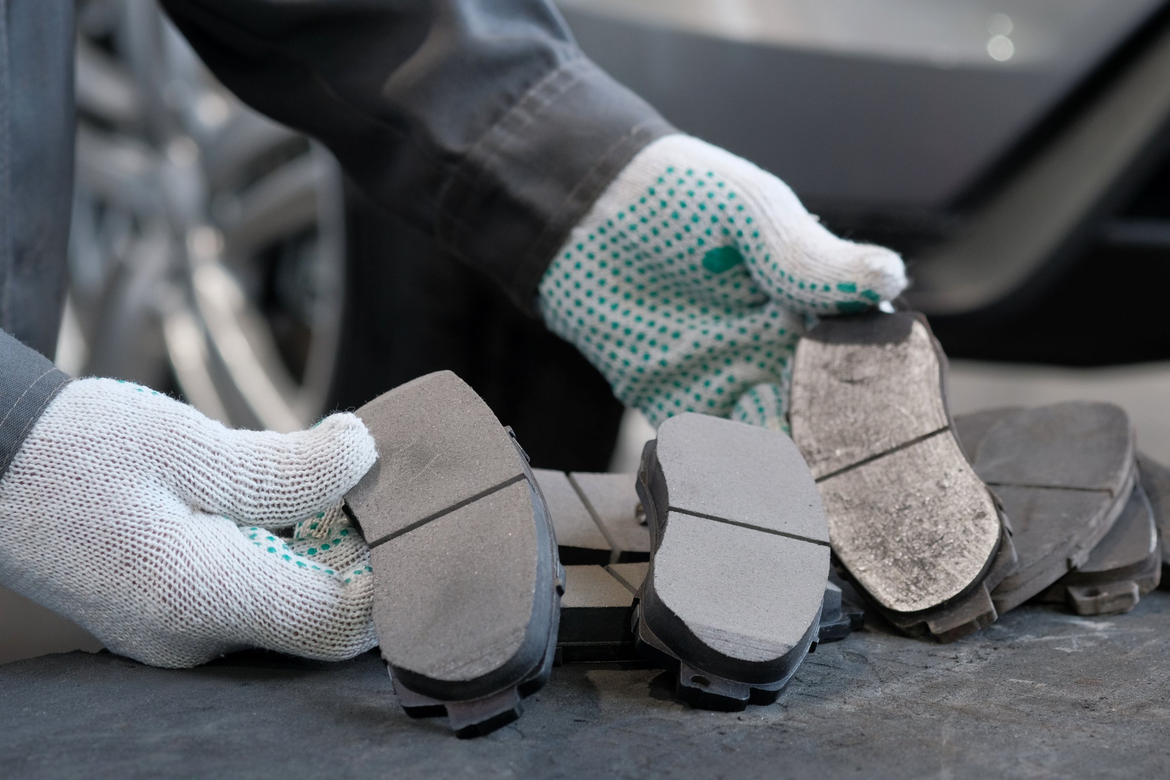 Mechanic showing brake pads wear