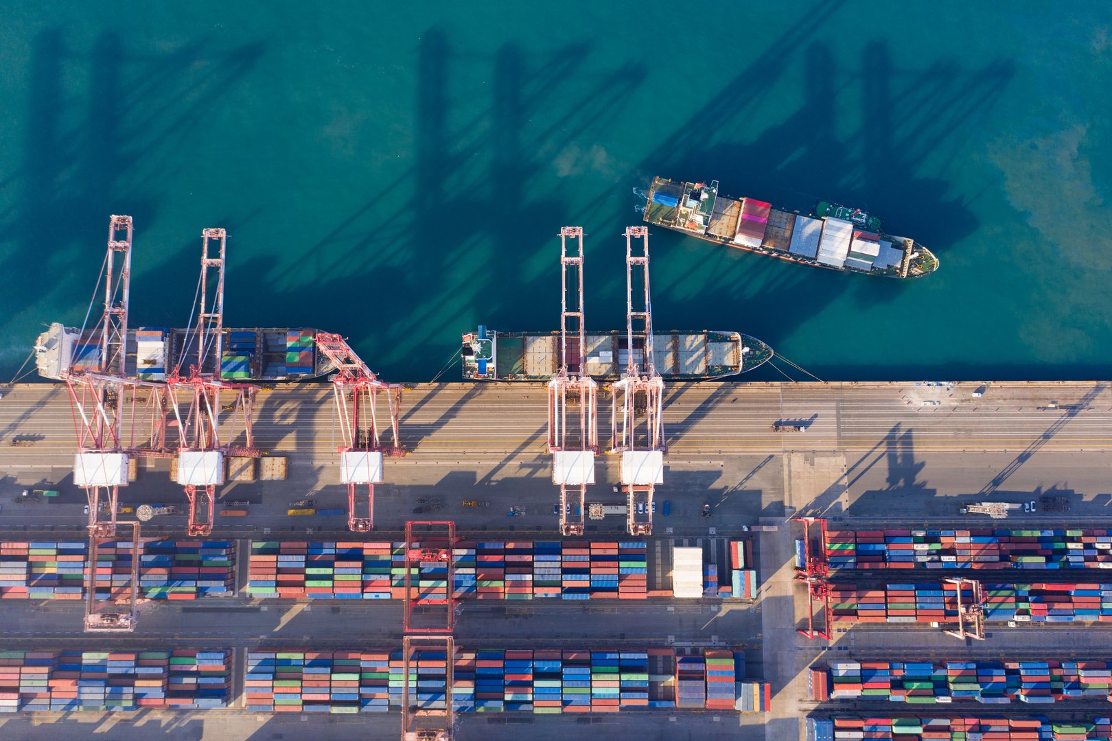Aerial view sea port warehouse and container ship or crane ship working for delivery containers shipment. Suitable use for transport or import export to global logistics, Container ship in import export and business logistic, Container ship loading and unloading in deep sea port.