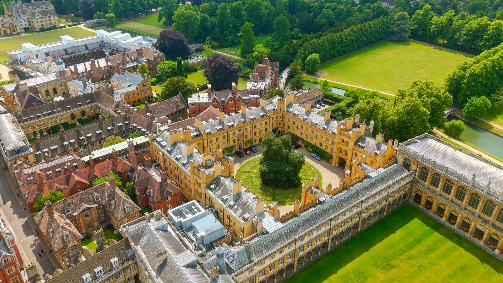 Stunning aerial view of Cambridge University campus, showcasing its historic architecture, green quads, and surrounding landscape in Cambridge, England