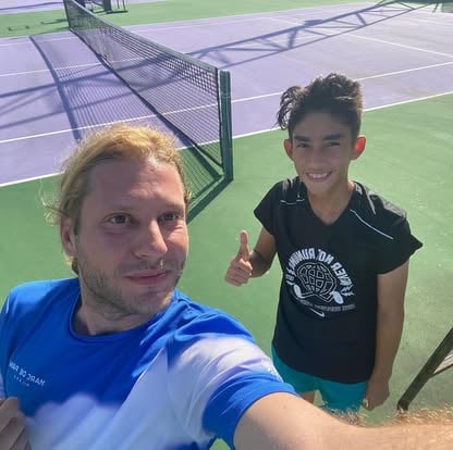 JP coaching students on the tennis court