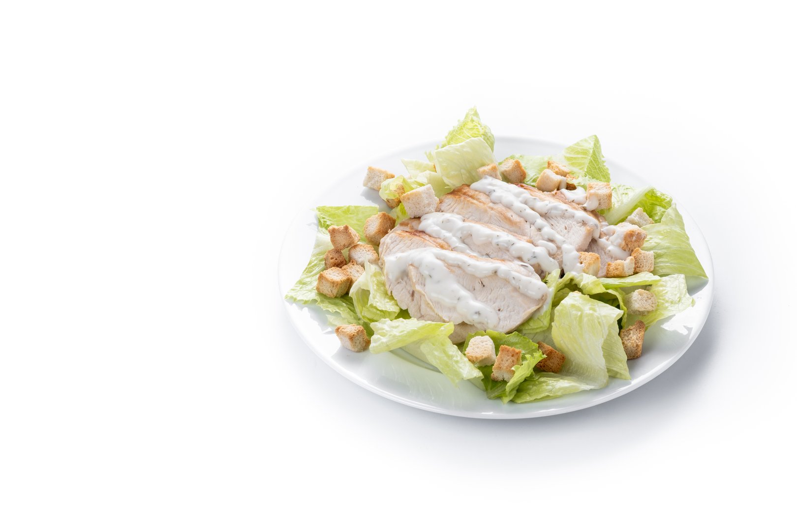 Crunchy Caesar salad with chicken on wooden table