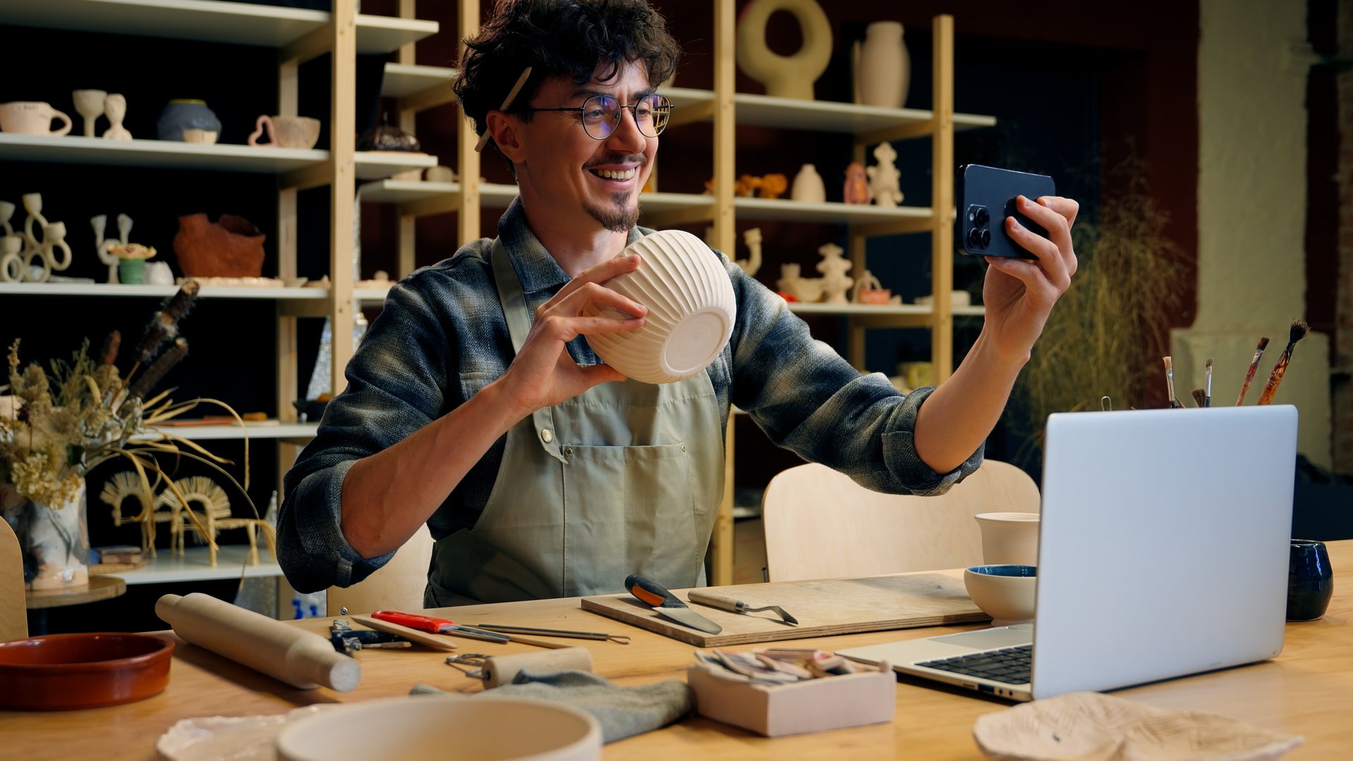 Small business owner Caucasian man guy artist potter salesman blogger influencer mobile phone photo male sculptor craft sale online blog ceramics sell online social media handmade in pottery workshop
