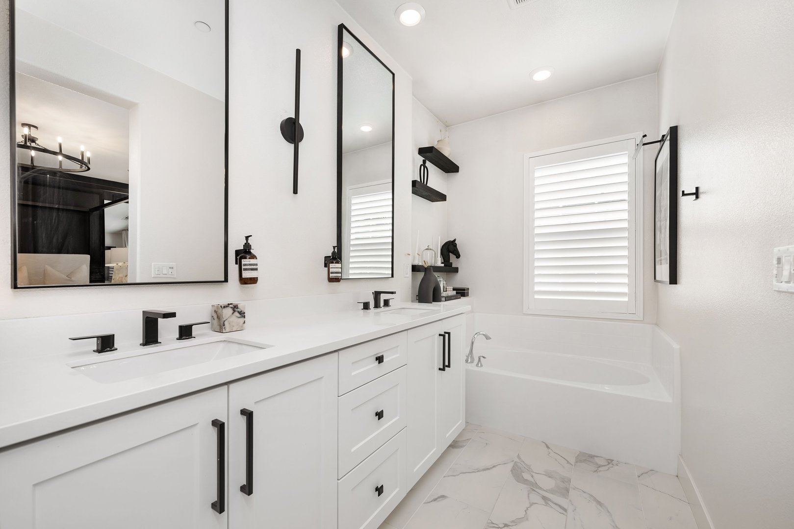 Modern bathroom with white cabinets and black fixtures