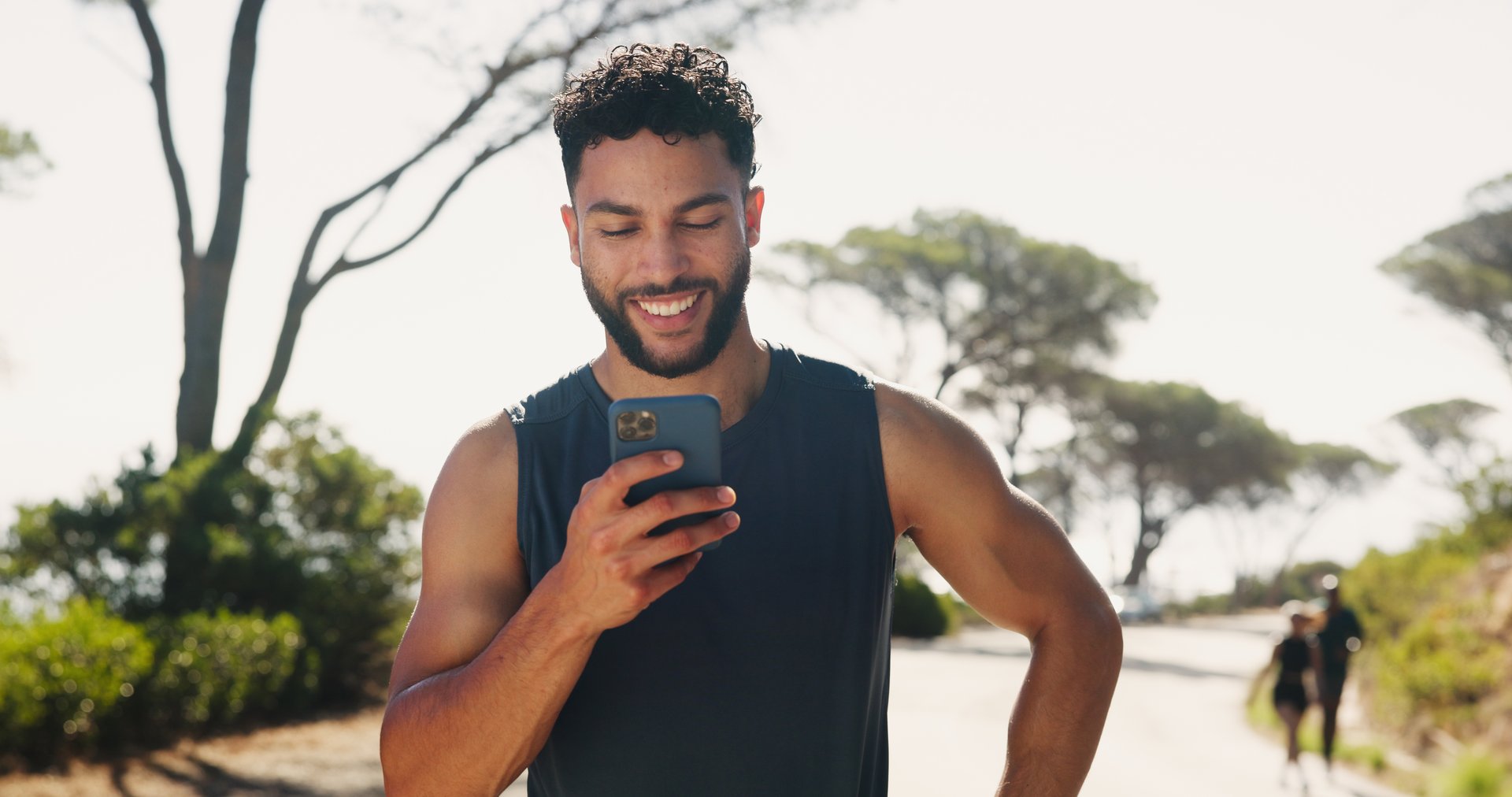 Outdoor, athlete and man with smartphone, fitness and planning for workout on app, happy and nature. Browsing, online and tracking performance on website, digital and runner with mobile for exercise