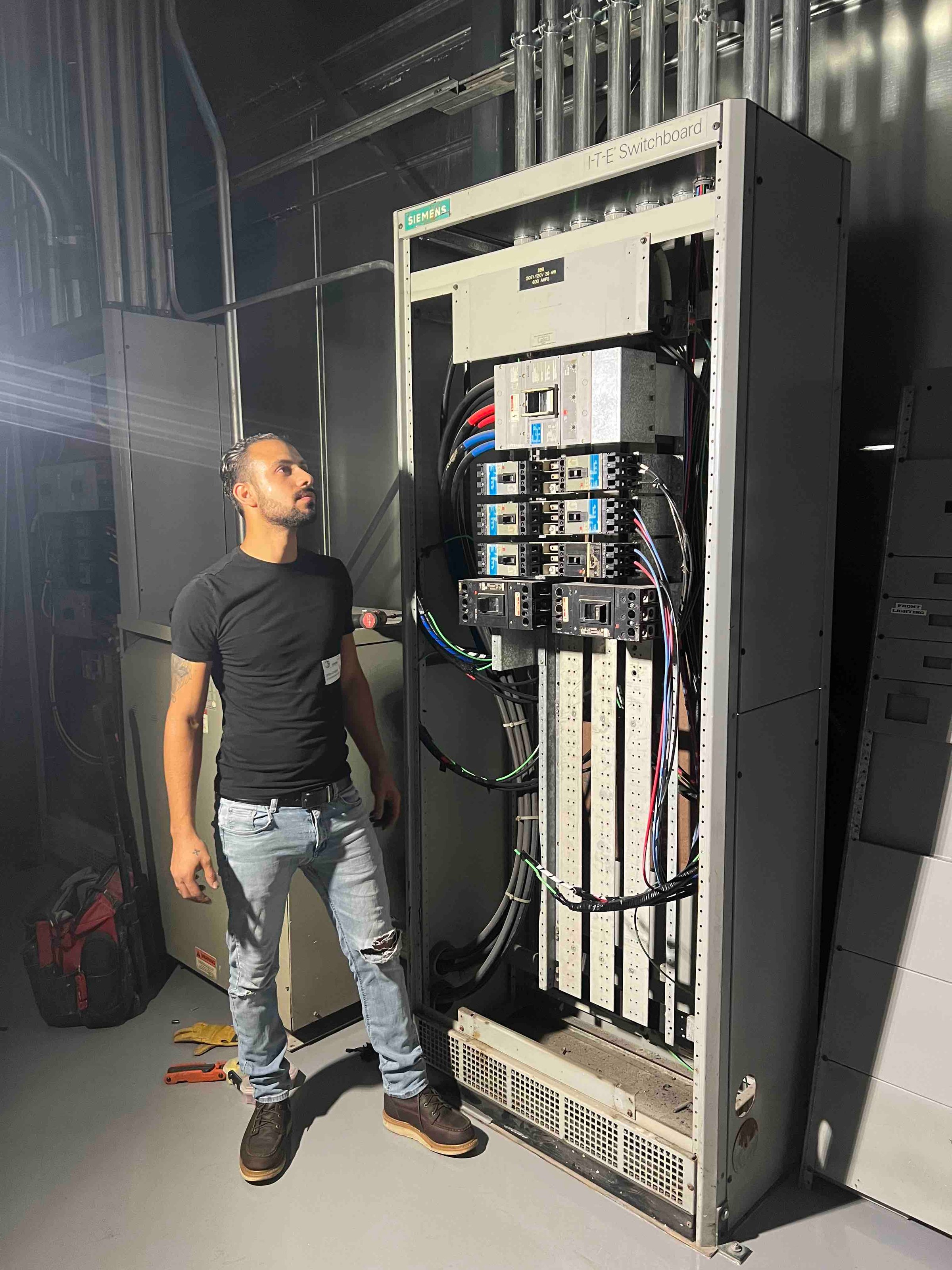 Electrician working on warehouse electrical panel