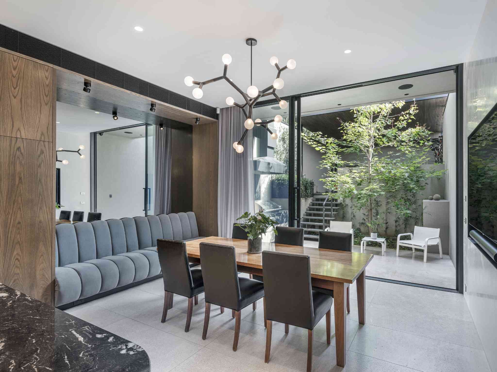 Modern kitchen featuring sleek integrated appliances and timber cabinetry by Individual Design