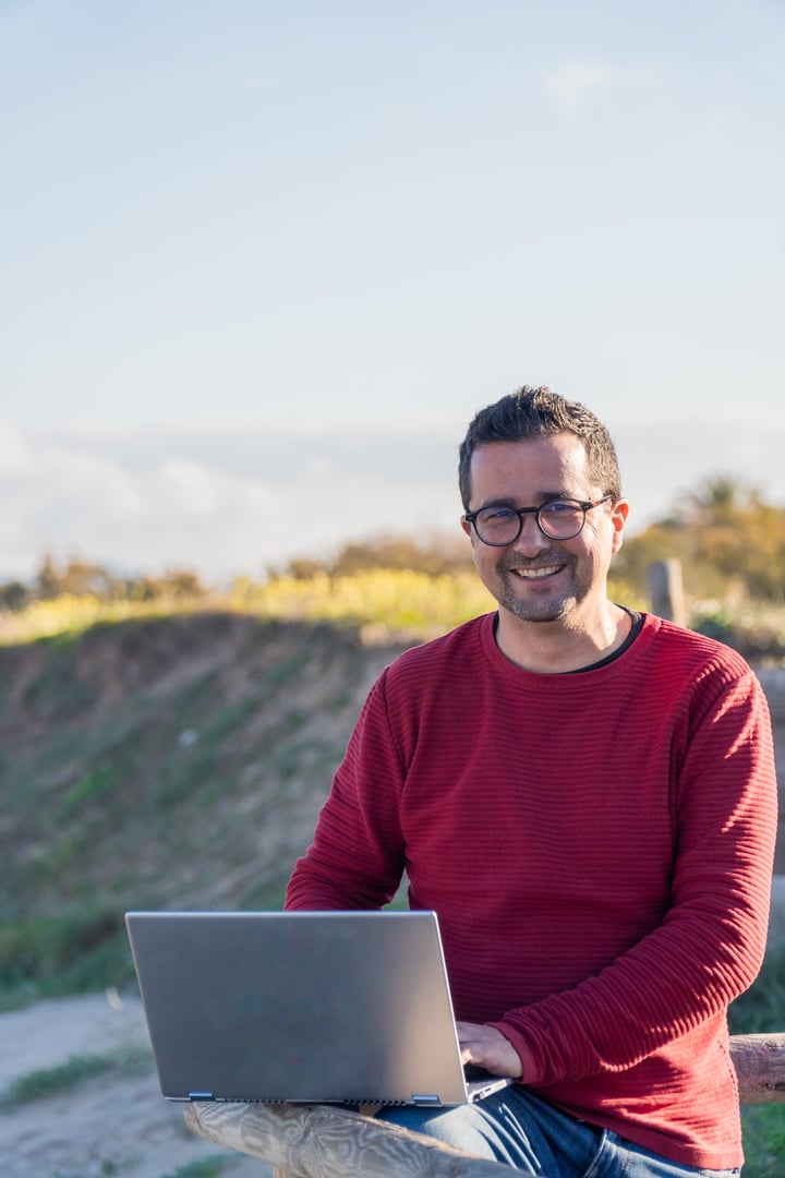 A man working on a computer outdoors, digital nomad freelance concept