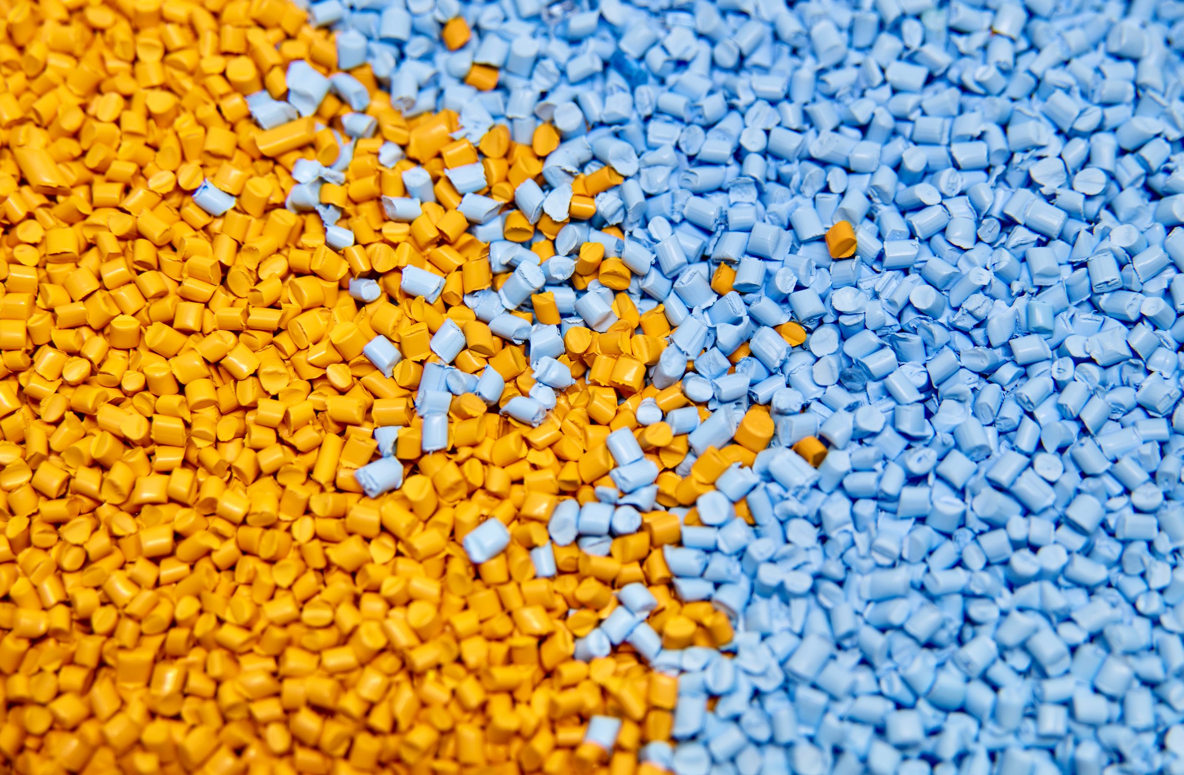 Blue and yellow plastic polymer granules