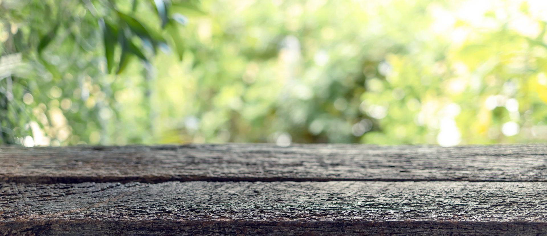 Old wooden table with soft natural bokeh background