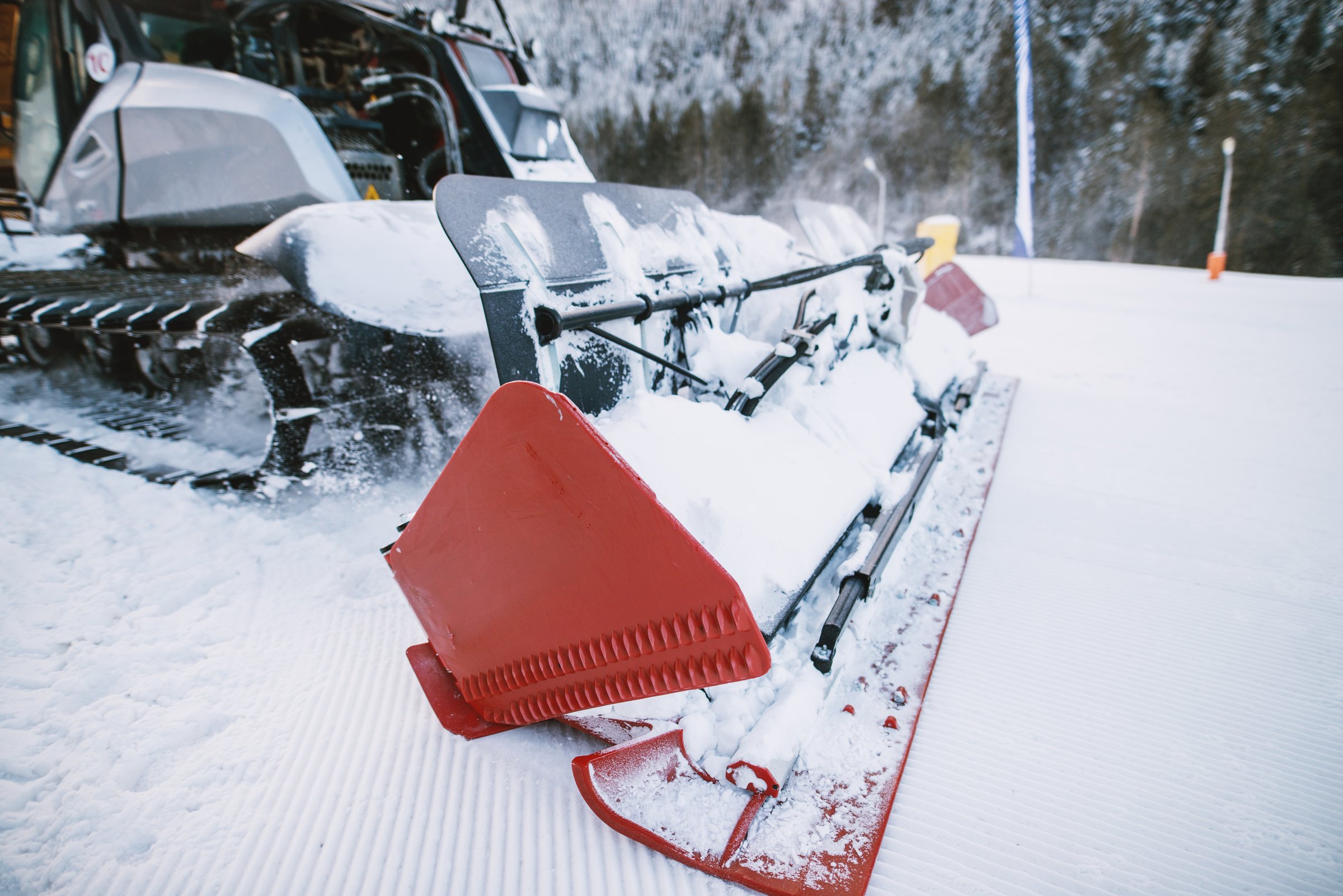 Close up view of special snow vehicle with the caterpillar on the snow in winter.